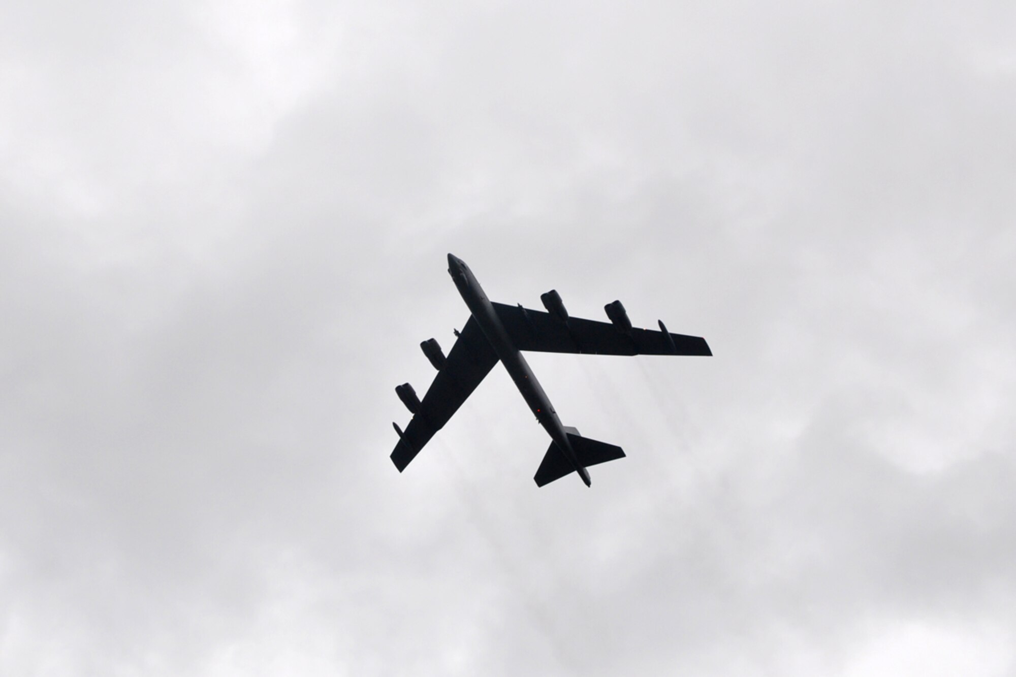A B-52 Stratofortress performs a flyover at the end of the RAIDR 21 Remembrance Ceremony at Barksdale Air Force Base, La., July 21, 2009. Family, friends and more than 200 Airmen were in attendance at the ceremony that remembered the six aircrew members of RAIDR 21, who were lost a year ago today, off the coast of Guam. (U.S. Air Force photo/Tech. Sgt. Jeff Walston)