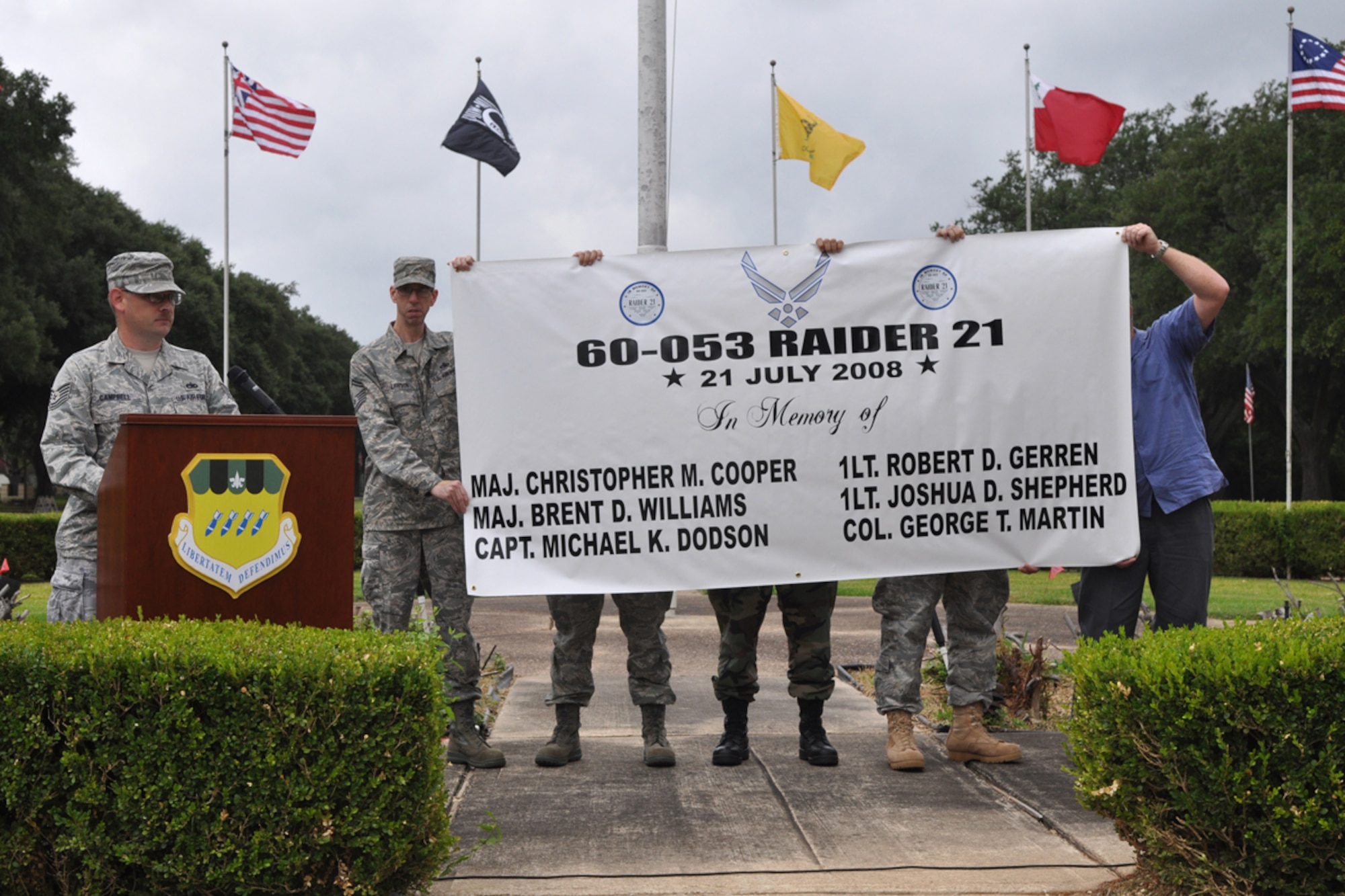 Members of the Barksdale Freedom Riders display a banner during the RAIDR 21 Remembrance Ceremony at 2nd Bomb Wing Headquarters flag pole on Barksdale Air Force Base, La., July 21, 2009. The ceremony remembered the crew of RAIDR 21, a B-52 Startofortress that crashed off the coast of Guam a year ago today. The Barksdale Freedom Riders is an organization that focuses on safety, Camaraderie and Esprit De Corps and giving back to the community. (U.S. Air Force photo/Tech. Sgt. Jeff Walston) 