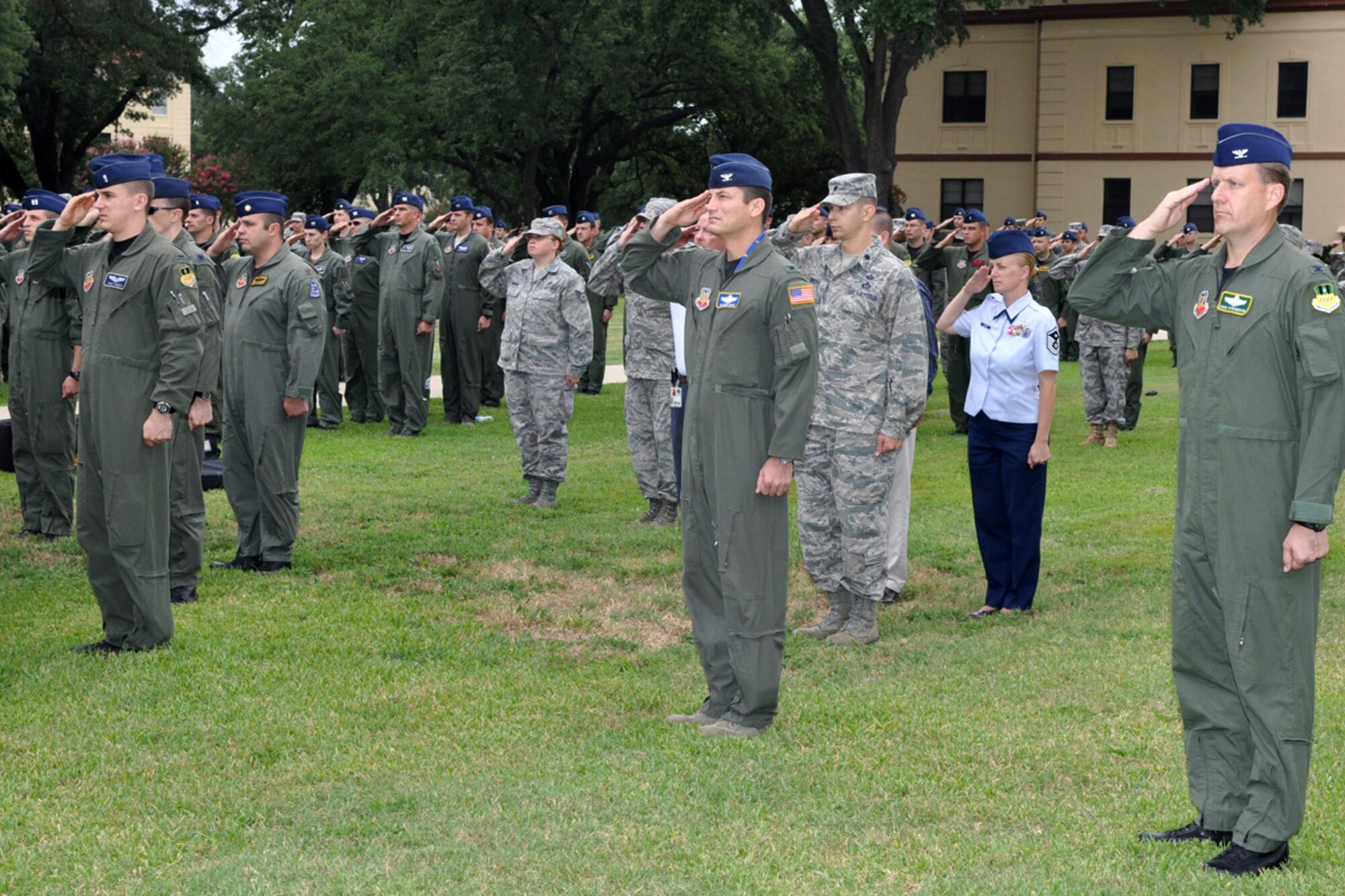 Barksdale Airmen salute as the colors are posted during the RAIDR 21 Remembrance Ceremony at the 2nd Bomb Wing Headquarters flag pole at Barksdale Air Force Base, La., July 21, 2009. The ceremony remembered the crew of RAIDR 21, a B-52 Startofortress that crashed off the coast of Guam a year ago today. (U.S. Air Force photo/Tech. Sgt. Jeff Walston) 