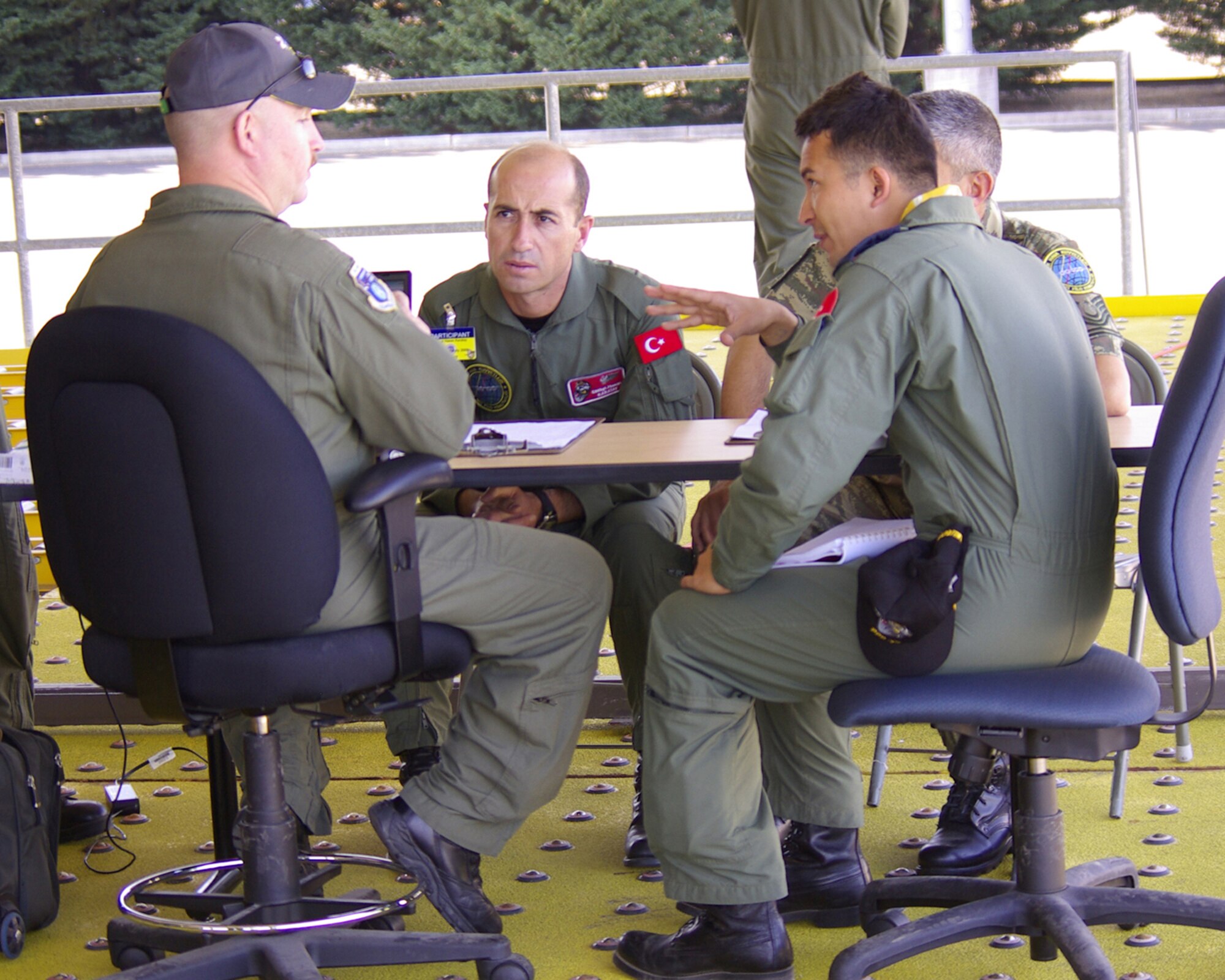Chief Master Sgt. Gaglayan Kilig (center) of the Turkish Air Force listens July 21, 2009, as an umpire clarifies an evaluation point to their interpreter just before his crew is assessed during a Joint Inspetion competition during Air Mobility RODEO 2009, a bi-annual international competition at McChord Air Force Base, Wash.  RODEO provides a forum for Airmen from around the globe to share best practices that enhance ground and flight crew skill sets.  (U.S. Air Force photo/ Tech. Sgt. Steve Wilkins_