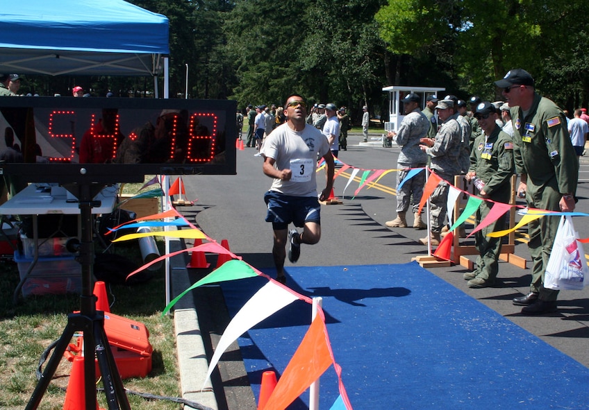 A competitor in the fit-to-fight competition finishes the 1.5-mile run during action for Air Mobility Command's RODEO 2009 July 19 at McChord Air Force Base, Wash.  More than 100 teams are participating in RODEO competition, including teams from seven foreign countries. RODEO is the U.S. Air Force's and AMC's premier air mobility competition. It's an international combat skills and flying operations competition designed to develop and improve techniques, procedures and interoperability with international partners to optimize mobility partnerships and enhance mobility operations. (U.S. Air Force Photo/Tech. Sgt. Scott T. Sturkol)