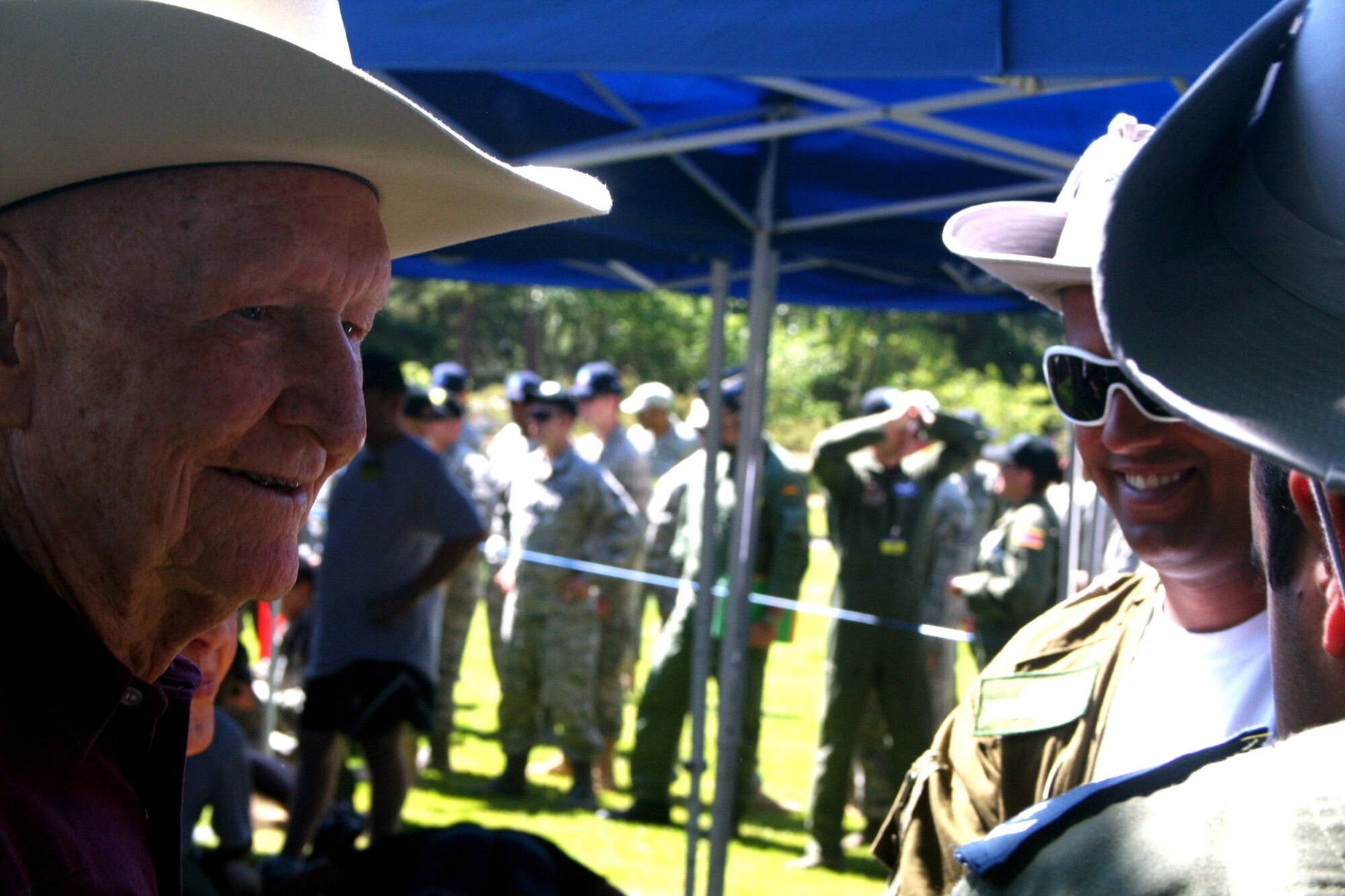 Retired Col. Gail Halvorson, also known as the "Candy Bomber" for his participation in the Berlin Airlift in 1947, greets some international competitors during Air Mobility Command's RODEO 2009 July 19 at McChord Air Force Base, Wash.  More than 100 teams are participating in RODEO competition, including teams from seven foreign countries. RODEO is the U.S. Air Force's and AMC's premier air mobility competition. It's an international combat skills and flying operations competition designed to develop and improve techniques, procedures and interoperability with international partners to optimize mobility partnerships and enhance mobility operations. (U.S. Air Force Photo/Tech. Sgt. Scott T. Sturkol)
