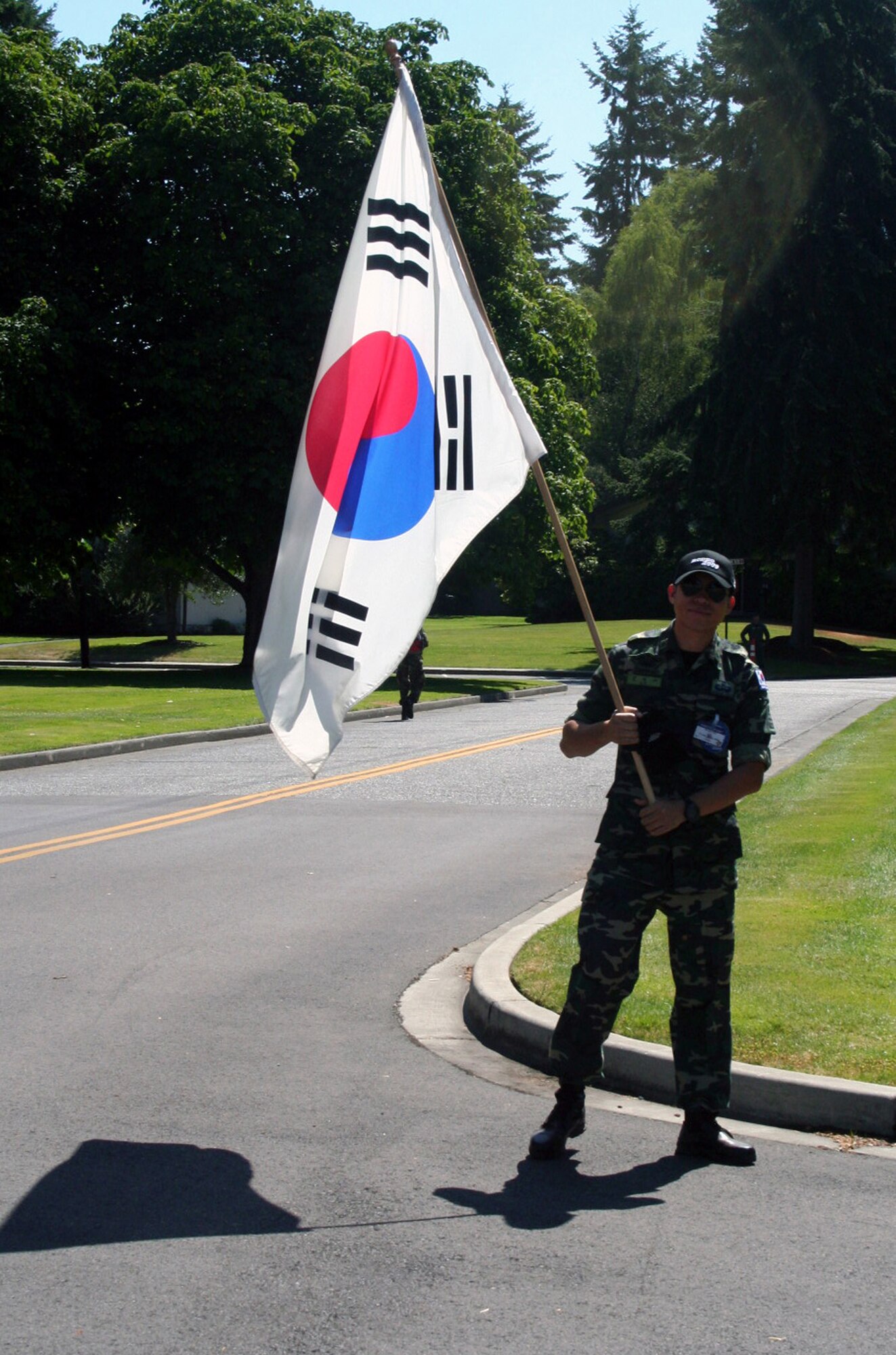 A member of the Republic of Korea team cheers on participants in the fit-to-fight competition for Air Mobility Command's RODEO 2009 July 19 at McChord Air Force Base, Wash.  More than 100 teams are participating in RODEO competition, including teams from seven foreign countries. RODEO is the U.S. Air Force's and AMC's premier air mobility competition. It's an international combat skills and flying operations competition designed to develop and improve techniques, procedures and interoperability with international partners to optimize mobility partnerships and enhance mobility operations. (U.S. Air Force Photo/Tech. Sgt. Scott T. Sturkol)