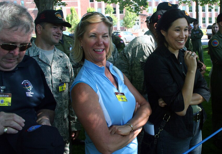 Distinguished visitors from McGuire Air Force Base, N.J., led by Ms. Angel Lopez (right) of the 87th Air Base Wing public affairs office, watch the fit-to-fight competition for Air Mobility Command's RODEO 2009 July 19 at McChord Air Force Base, Wash.  More than 100 teams are participating in RODEO competition, including teams from seven foreign countries. RODEO is the U.S. Air Force's and AMC's premier air mobility competition. It's an international combat skills and flying operations competition designed to develop and improve techniques, procedures and interoperability with international partners to optimize mobility partnerships and enhance mobility operations. (U.S. Air Force Photo/Tech. Sgt. Scott T. Sturkol)