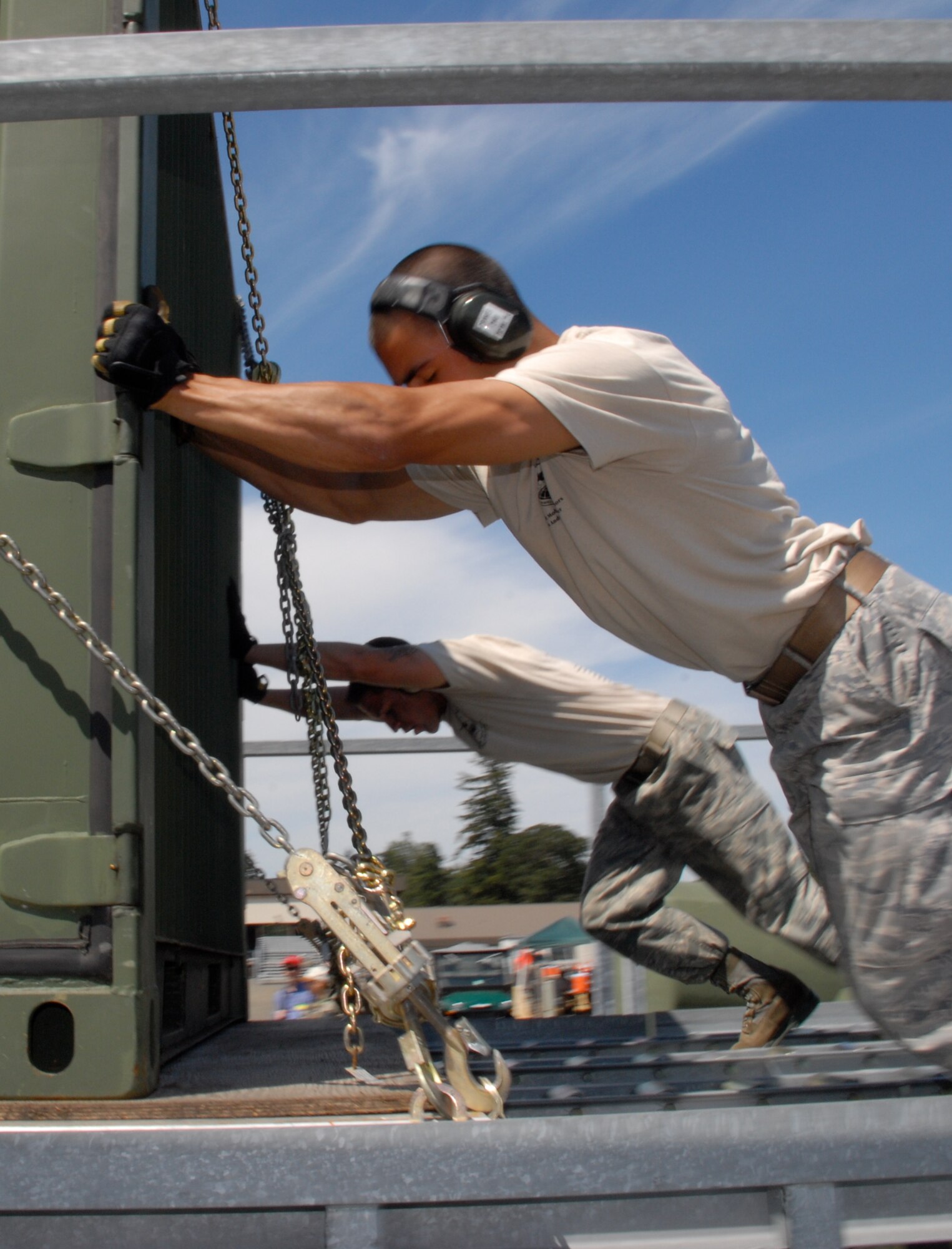 MCCHORD AIR FORCE BASE, Wash. – Senior Airman Andrew Cramer, 732th Air Mobility Squadron, Elmendorf Air Force Base, Alaska (close), and Staff Sgt. Clifton Robertson, 735th Air Mobility Squadron, Hickam Air Force Base, Hawaii, off-load 60,000 tons of cargo from the flightline here during the Air Mobility Rodeo 2009 July 20. The Rodeo takes place here July 19-25. Both Airmen are part of the 515th Air Mobility Operatons Wing team from Hickam AFB, which will compete against 22 other aerial port teams. Events include C-130 engine running on and off load, joint inspection with hazmat, in-transit visibility, 60,000-ton driving course, and a 10,000-ton forklift driving course. (U.S. Air Force photo/Staff Sgt. Carolyn Viss)