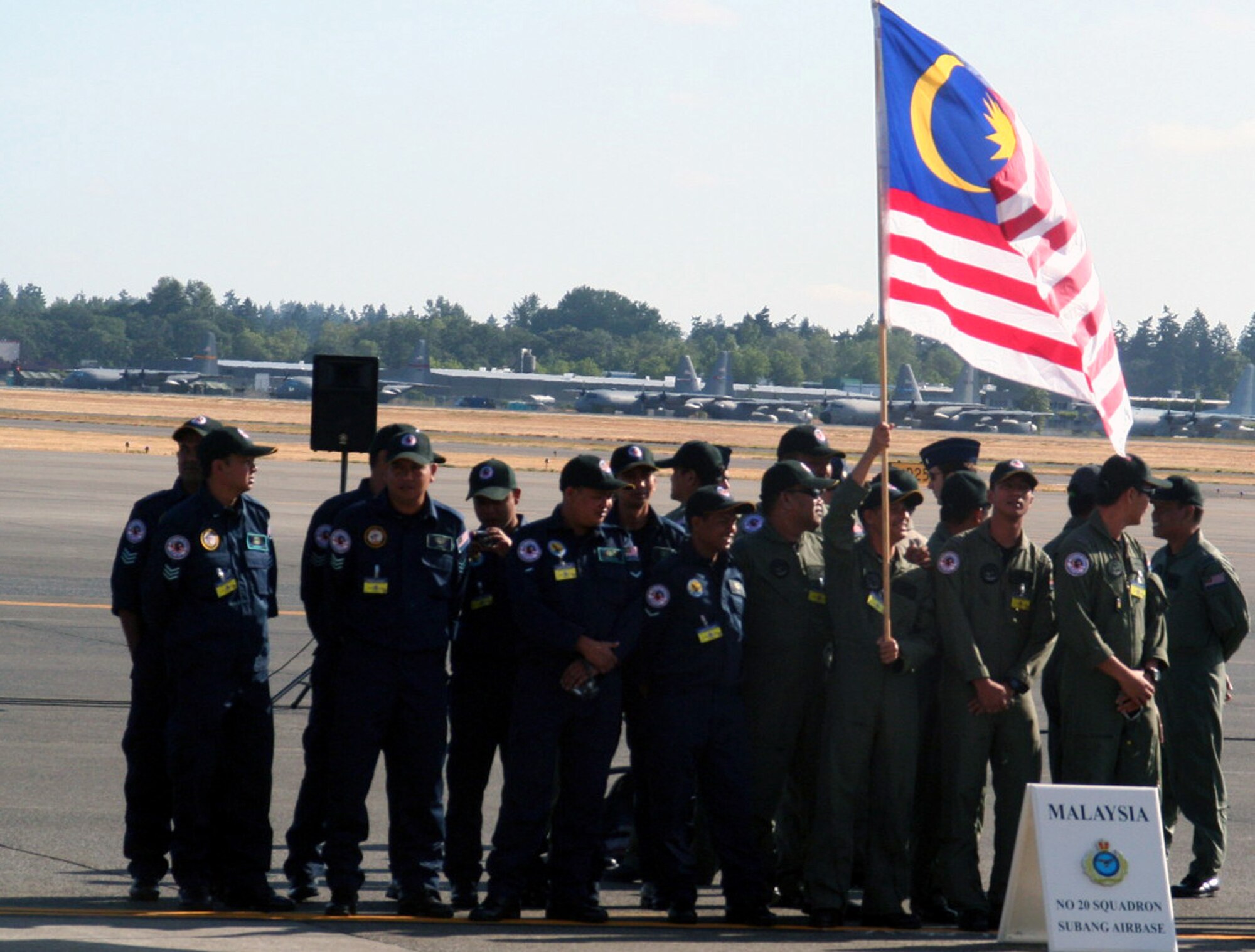 Members of the Malaysian team prepare for opening ceremonies for Air Mobility Command's RODEO 2009 July 19 at McChord Air Force Base, Wash.  More than 100 teams are participating in RODEO competition, including teams from seven foreign countries. RODEO is the U.S. Air Force's and AMC's premier air mobility competition. It's an international combat skills and flying operations competition designed to develop and improve techniques, procedures and interoperability with international partners to optimize mobility partnerships and enhance mobility operations. (U.S. Air Force Photo/Tech. Sgt. Scott T. Sturkol)