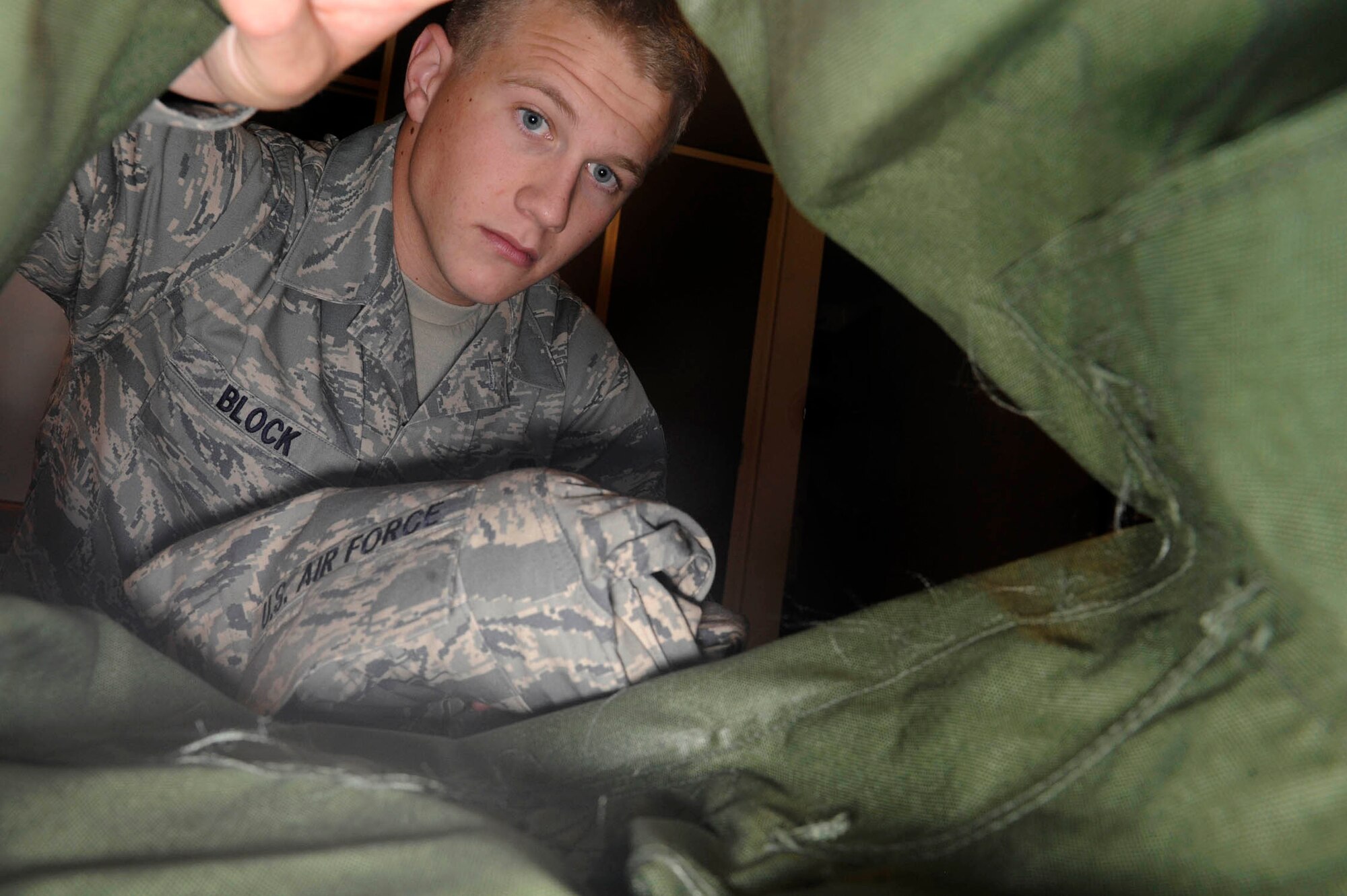 Airman 1st Class Preston Block, 37th Bomb Squadron crew chief assigned to the 28th Aircraft Maintenance Squadron, packs his deployment bag while in his dorm room for an upcoming deployment, July 14. The deployment is sending aircrew, support personnel, maintainers, logistics readiness personnel and expeditionary combat support Airmen to various locations in Southwest Asia in support of Global War on Terror. (U.S. Air Force photo by Airman 1st Class Corey Hook)





