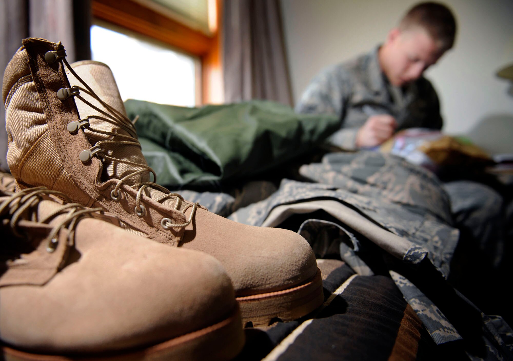Airman 1st Class Preston Block, 37th Bomb Squadron crew chief assigned to the 28th Aircraft Maintenance Squadron, labels a bag of hygiene products while he packs in his dorm room for an upcoming deployment, July 14. The deployment is sending aircrew, support personnel, maintainers, logistics readiness personnel and expeditionary combat support Airmen to various locations in Southwest Asia in support of Global War on Terror.  (U.S. Air Force photo by Airman 1st Class Corey Hook)