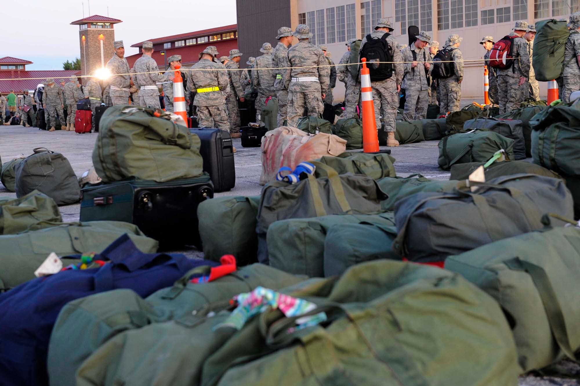 Members of the 28th Bomb Wing prepare to initially in-process and check their luggage before deploying July 21. Ellsworth Airmen in various roles deployed in support of operations at the 379th Air Expeditionary Wing in Southwest Asia. (U.S. Air Force photo by Airman 1st Class Corey Hook)