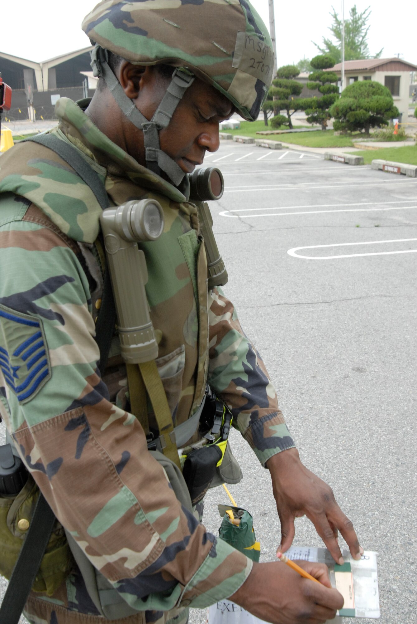 Master Sgt. Phillip Johnson, unit training manager for the 8th Logistic Readiness Squadron, marks the M-8 paper around the LRS compound July 20, at Kunsan Air Base, Republic of Korea. This Airman is participating in a week-long peninsula wide operational readiness exercise that ended July 24. (U.S. Air Force photo/Staff Sgt. Darnell T. Cannady)