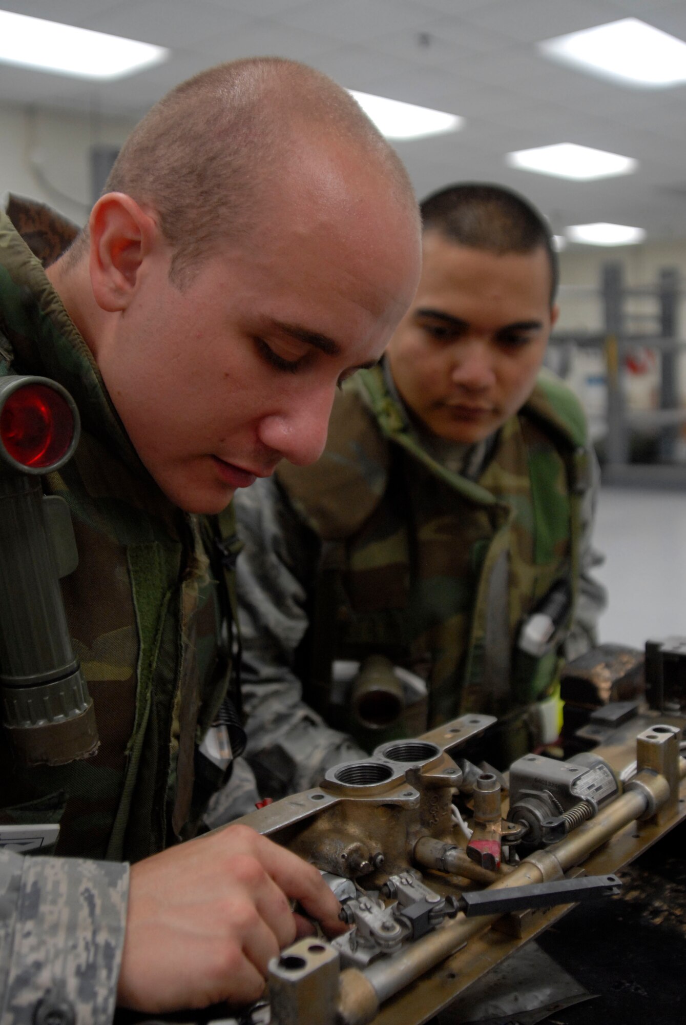 Staff Sgt. Anthony Horvath, aircraft armament systems craftsman assigned to the 8th Maintenance Squadron, explains the wiring system of the MAU-12 bomb rack to Airman Aaron Deleon Guerreo, aircraft armament systems journeyman assigned to the 8th Maintenance Squadron, July 21, at Kunsan Air Base, Republic of Korea.  These Airmen are participating in a peninsula wide operational readiness exercise that ended July 24. (U.S. Air Force photo/Staff Sgt. Darnell T. Cannady)