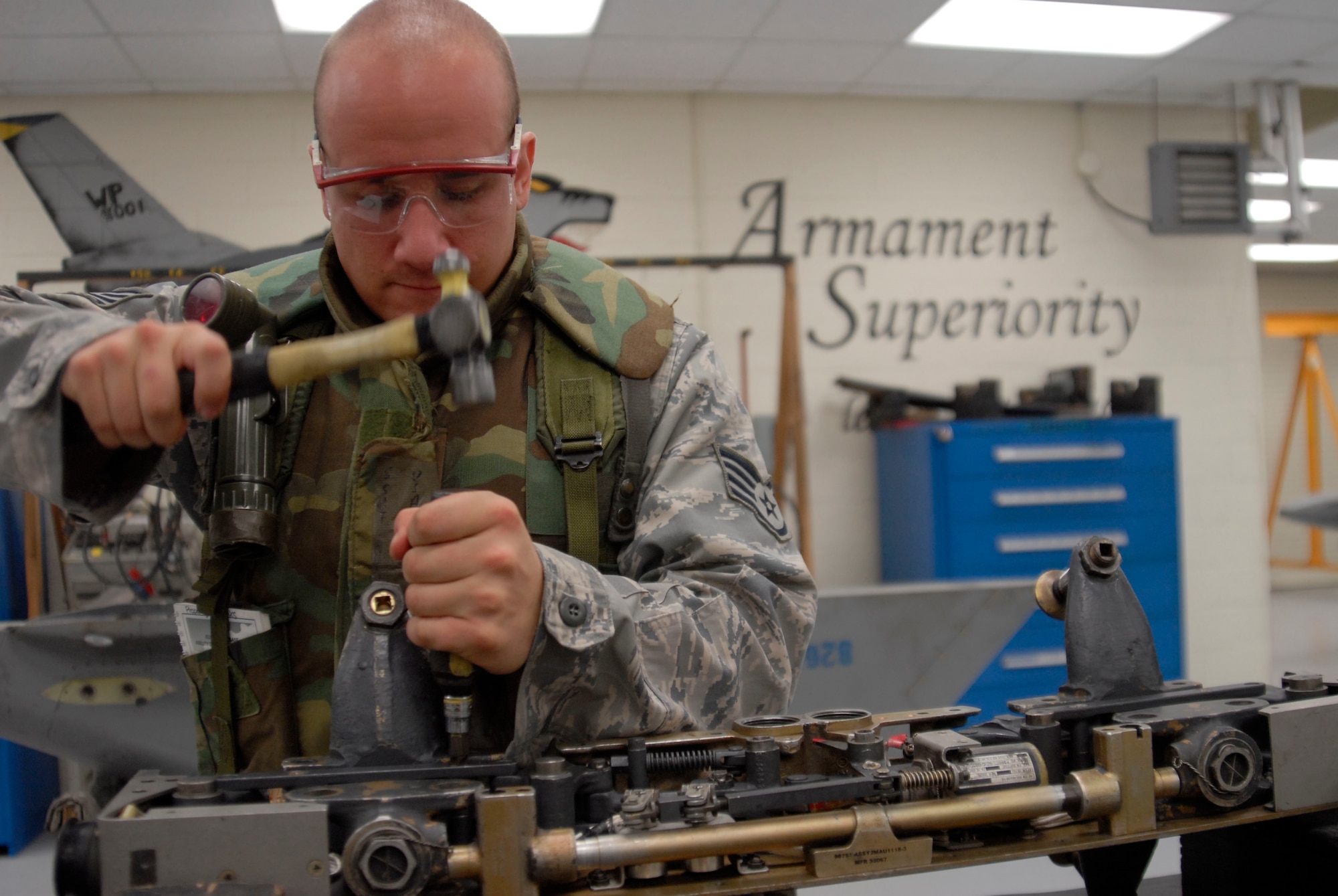 Staff Sgt. Anthony Horvath, aircraft armament systems craftsman assigned to the 8th Maintenance Squadron, dissembles the MAU-12 bomb rack using an impact hammer July 21, 2009 at Kunsan Air Base, Republic of Korea. Sergeant Horvath is participating in a week-long peninsula wide operational readiness exercise that ended July 24.(U.S. Air Force photo/Staff Sgt. Darnell T. Cannady)