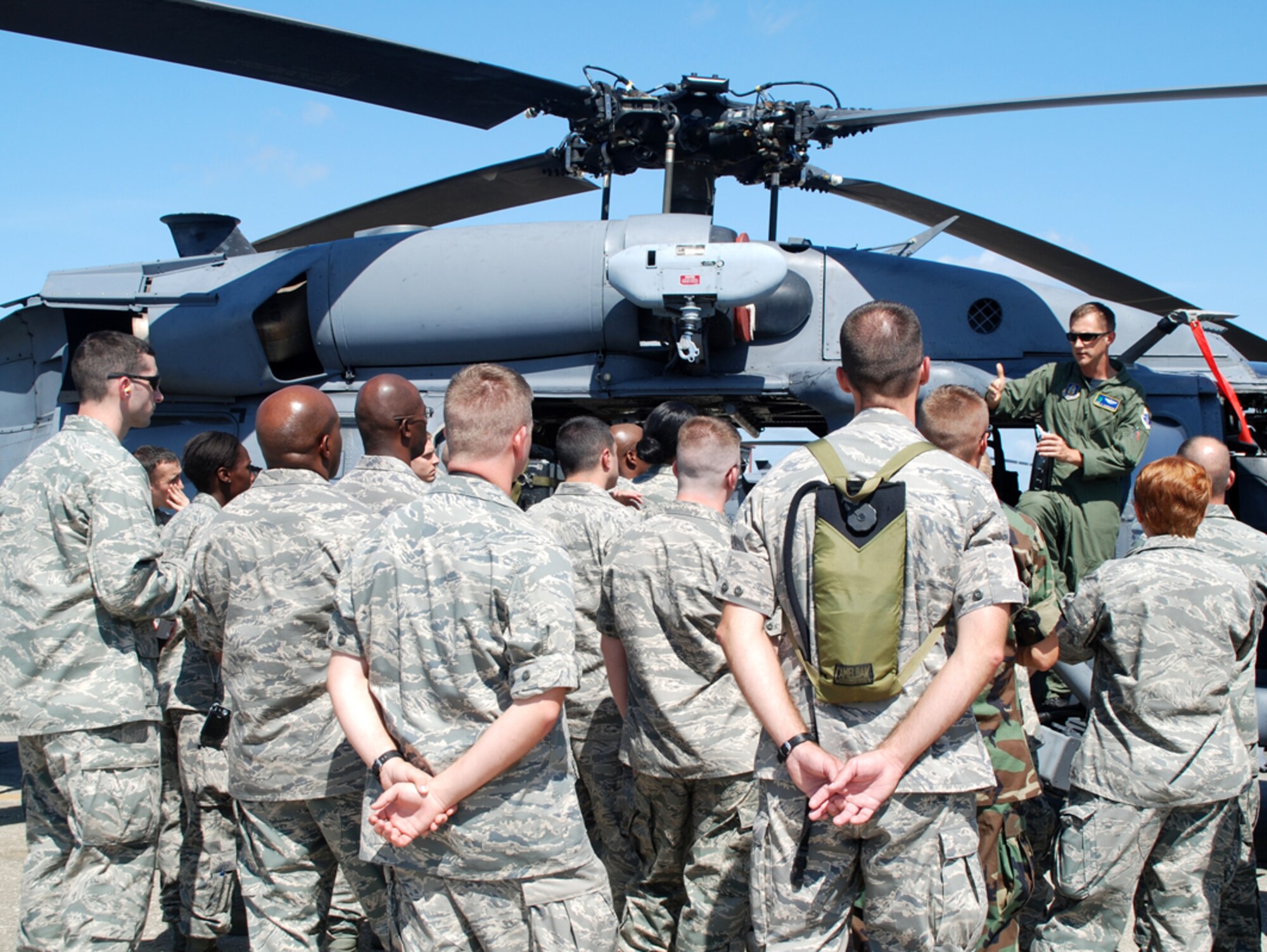 PATRICK AIR FORCE BASE, Fla. - Thirty nationwide Air Force Reserve chaplains gather around an HH-60G Pave Hawk helicopter as 920th Rescue Wing pilot Capt. Paul Carpenter gives them scenarios of his recent deployment to Afghanistan and discusses chopper capabilities.  The chaplains toured various Air Force bases in July to learn more about the variety of Air Force missions. The 920th Chaplain, Capt. Calvin Gittner, even tried recruiting someone to minister to the Rescue Wing Airmen to fill a void on his staff.  (U.S. Air Force photo/Capt. Cathleen Snow)