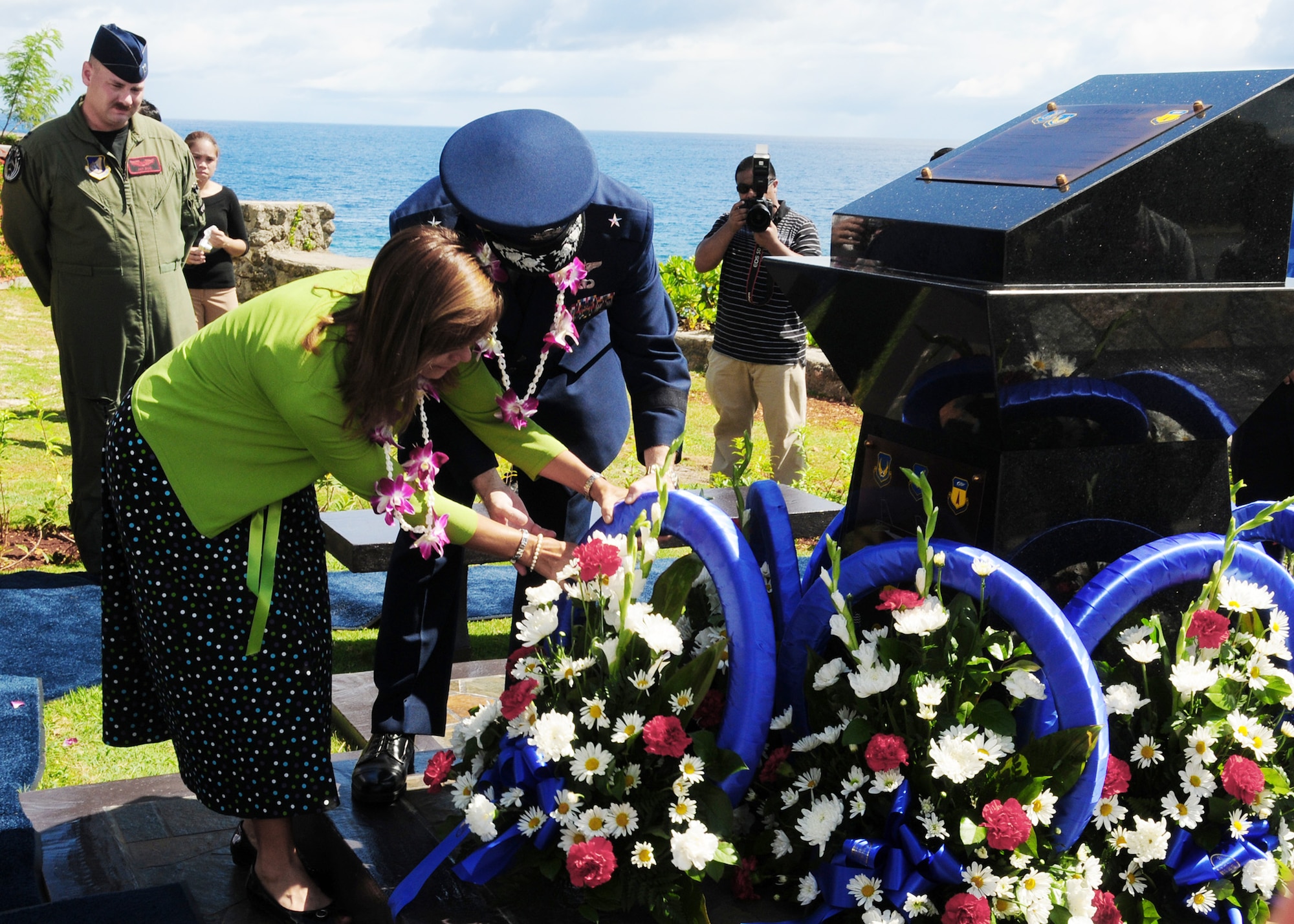 Brig. Gen. Phil Ruhlman, commander of the 36th Wing at Andersen Air Force Base, Guam, and wife Lina Ruhlman lay a wreath at the base of the RAIDR 21 Monument at the Governor's Complex at Adelup Point in Hagatna, Guam, July 20.  They placed the wreath in remembrance of the six Airmen who were lost July 21, 2008, when a B-52 Stratofortress -- call sign RAIDR 21 -- crashed off the coast of Guam during a mission.  More than 300 family, friends and guests attended the ceremony and monument unveiling.  (U.S. Air Force photo/Senior Airman Nichelle Anderson)
