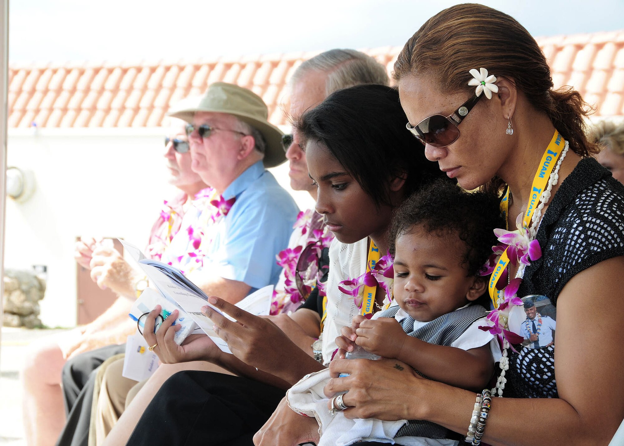 Ursula Martin, along with children Guahan (center) and Gemini, take a moment to reflect on the life of their loving husband and father, Col. George Martin, July 20 during a memorial unveiling ceremony at the Governor's Complex at Adelup Point in Hagatna, Guam.  More than 300 family, friends and guests attended the ceremony to remember the six aircrew members of the B-52 Stratofortress -- call sign RAIDR 21, who lost their lives when the bomber crashed July 21, 2008, about 25 miles off the coast of Guam. (U.S. Air Force photo/Senior Airman Nichelle Anderson)