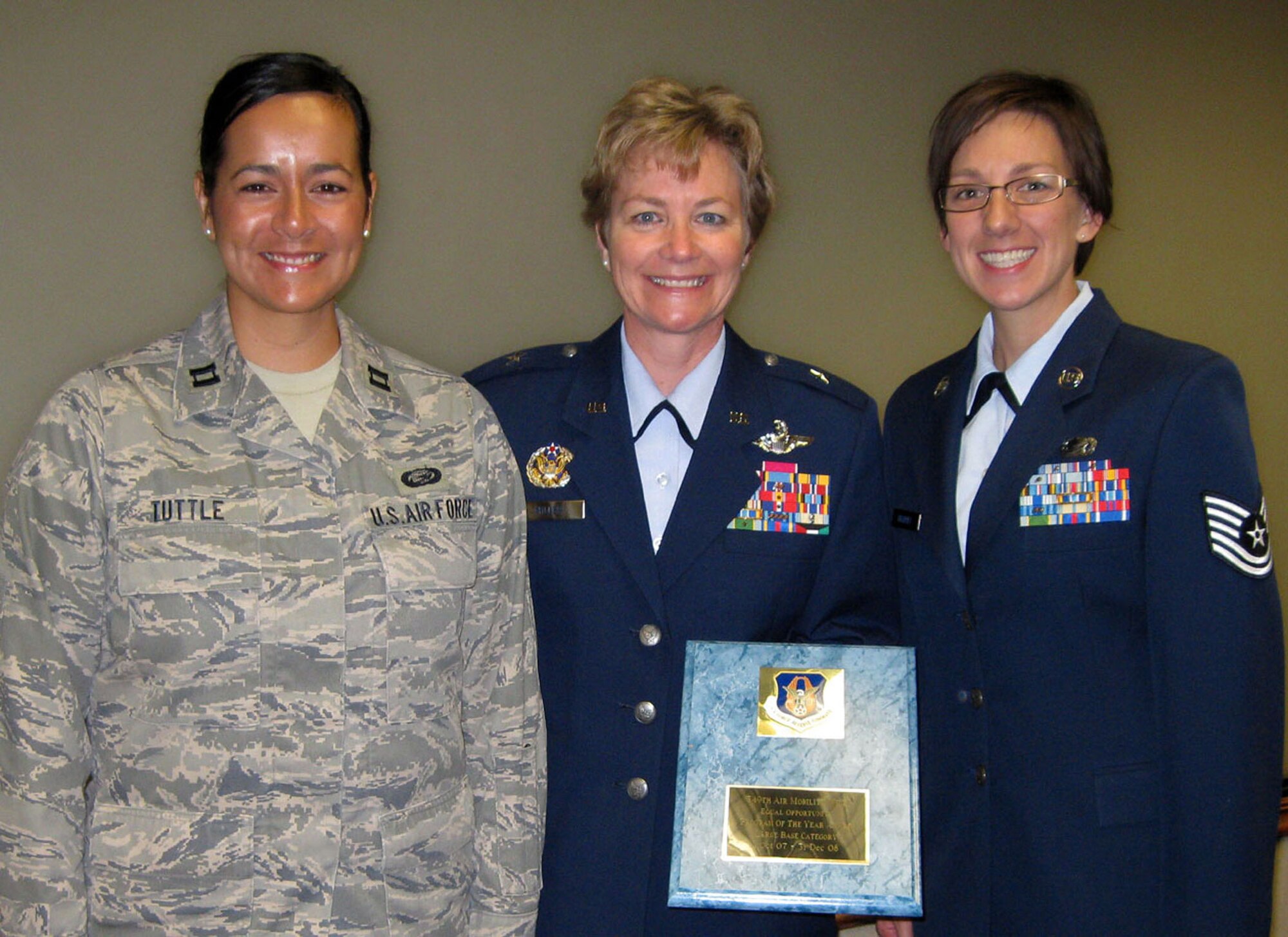TRAVIS AIR FORCE BASE, Calif. -- Brig. Gen. Maryanne Miller, 349th Air Mobility Wing commander, presented a plaque to the 349th Equal Opportunity office July 12, 2009, during wing staff meeting. The office was recognized by Air Force Reserve Command as the best EO Program, large base category, for 2008. Accepting the award were, left, Capt. Clarissa Tuttle, chief of EO, and on the right, Tech. Sgt. Heather Bradley, who was also recognized as the 2008 AFRC EO Specialist of the Year. (U.S. Air Force photo/SSgt. Meredith Mingledorff)