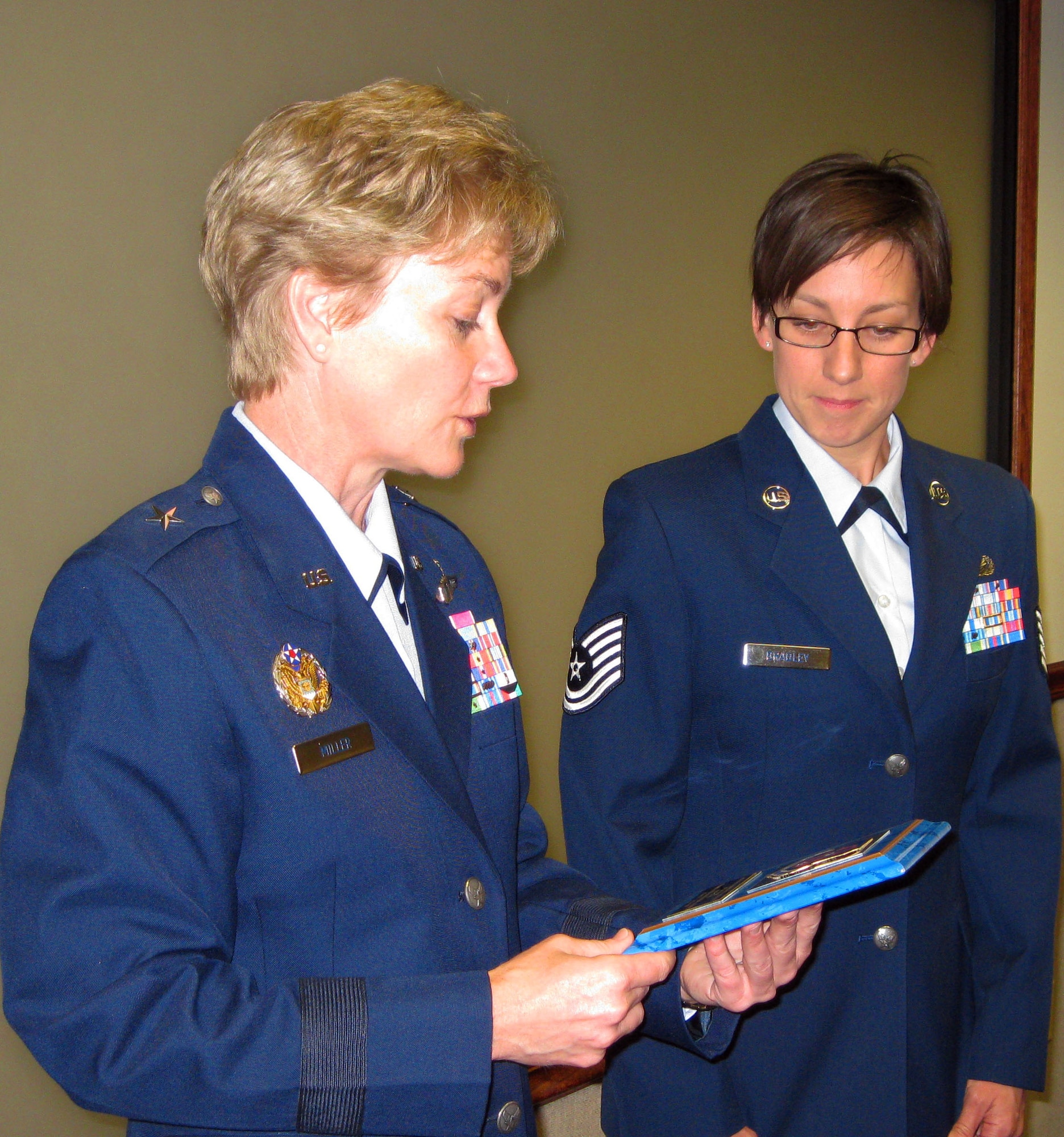 TRAVIS AIR FORCE, Calif. -- At the wing staff meeting July 12, 2009, Brig. Gen. Maryanne Miller, 349th Air Mobility Wing commander, recognized Tech. Sgt. Heather Bradley with a plaque. Sergeant Bradley was selected as the Air Force Reserve Command 2008 Equal Opportunity Specialist of the Year. She also was decorated with the Air Force Commendation Medal and received her Community College of the Air Force degree during the same meeting. (U.S. Air Force photo/SSgt. Meredith Mingledorff)                                