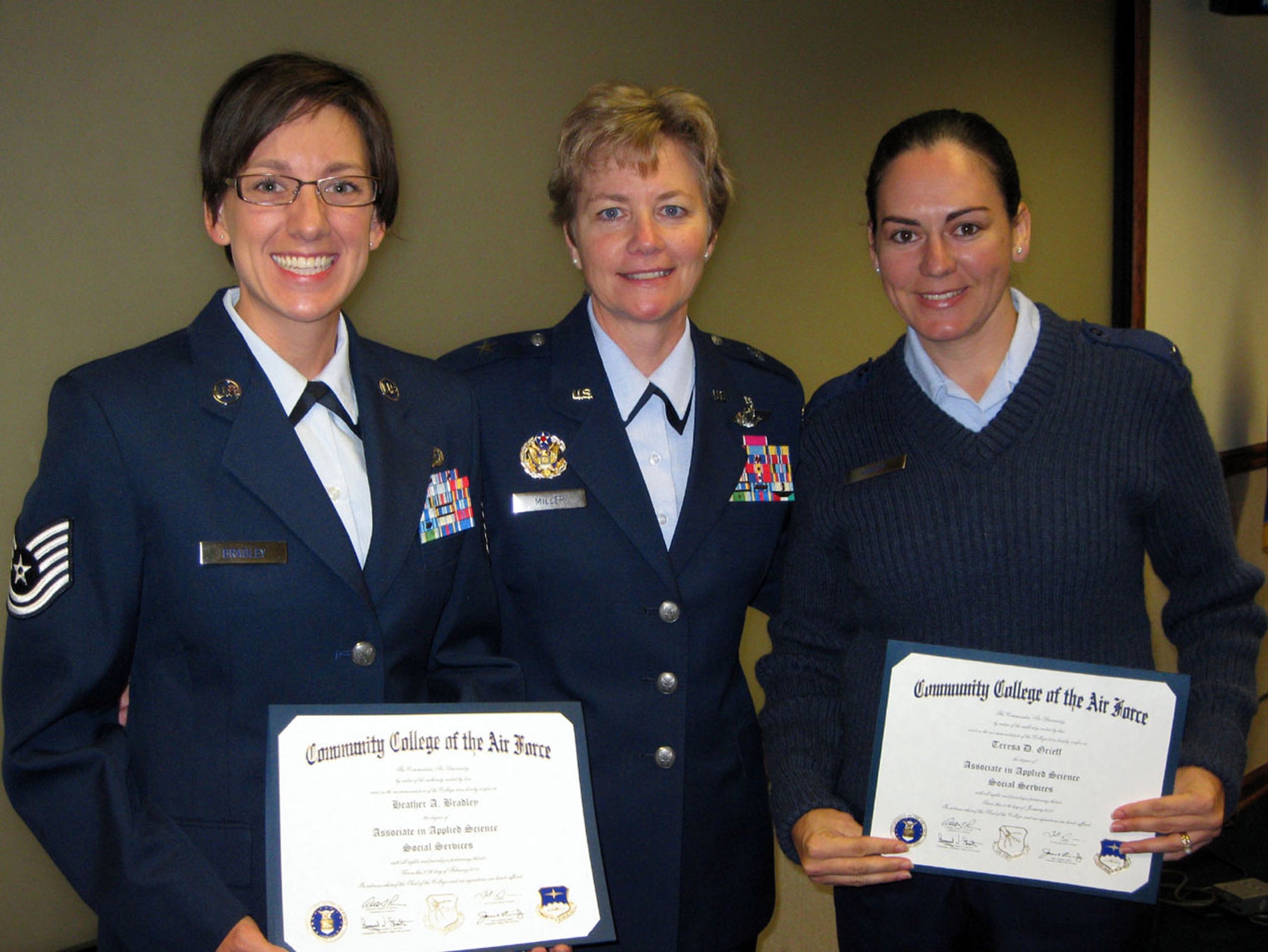 TRAVIS AIR FORCE BASE, Calif. -- During the 349th Air Mobility Wing staff meeting July 12, 2009, Brig. Gen. Maryanne Miller (center) presented two Community College of the Air Force degrees. Both Tech. Sgt. Heather Bradley, on the left, and Master Sgt. Teresa Grieff, right, received associates of applied science degrees in Social Services. Sergeant Bradley is assigned to the Equal Opportunity office, and Sergeant Grieff is assigned to the 349th Mission Support Squadron, and is also one of the elite members of the wing Honor Guard. (U.S. Air Force photo/SSgt. Meredith Mingledorff)