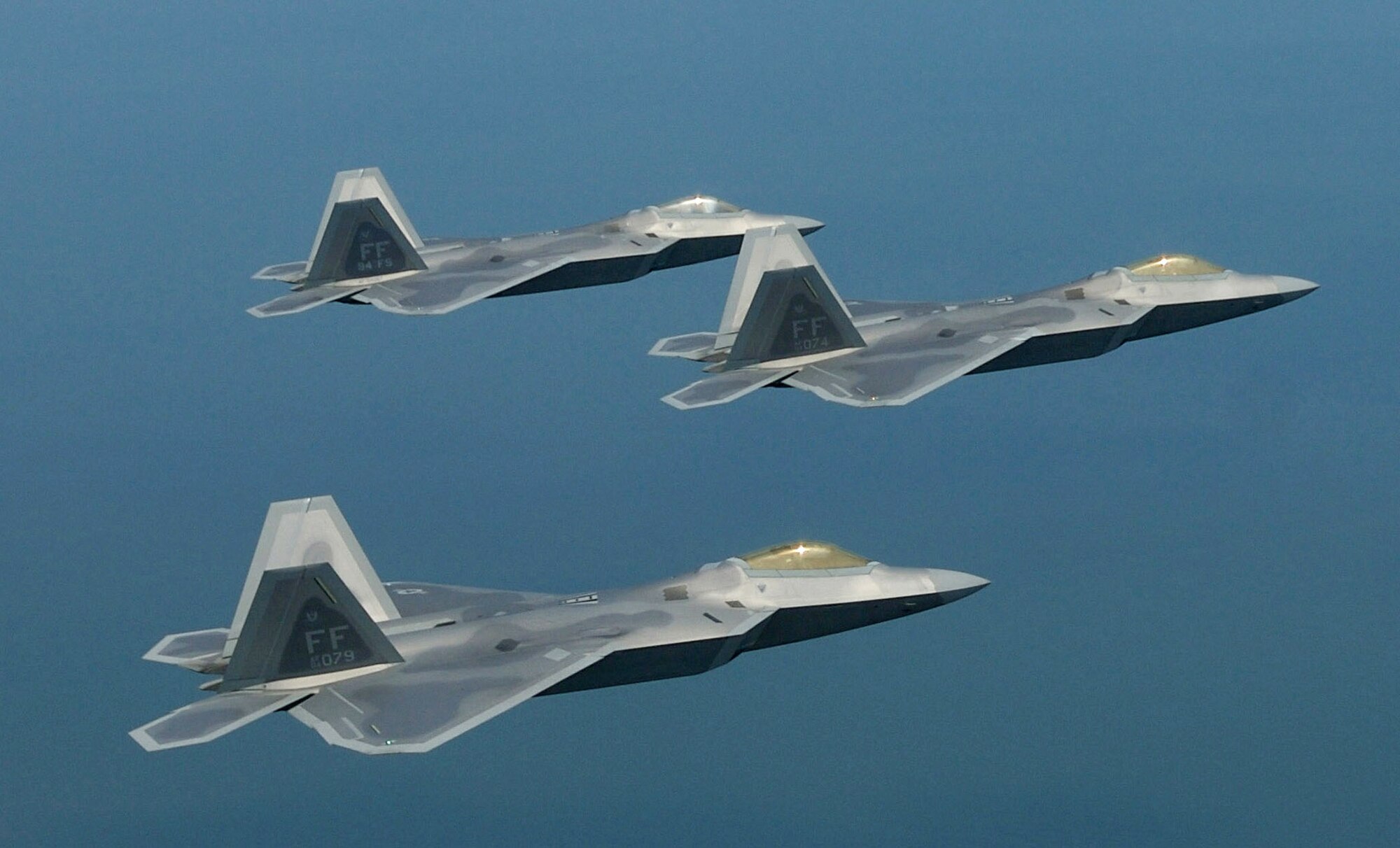 F-22 Raptors fly in formation. Air turbines used in the F-22s are now serviced by the 550th Commodities Maintenance Squadron at Tinker Air Force Base, Okla., as part of a new cooperative agreement with private manufacturers Lockheed Martin and Honeywell. The squadron will maintain more than 30 components from the high-tech air superiority fighter. (U.S. Air Force photo/Staff Sgt. Samuel Rogers) 
