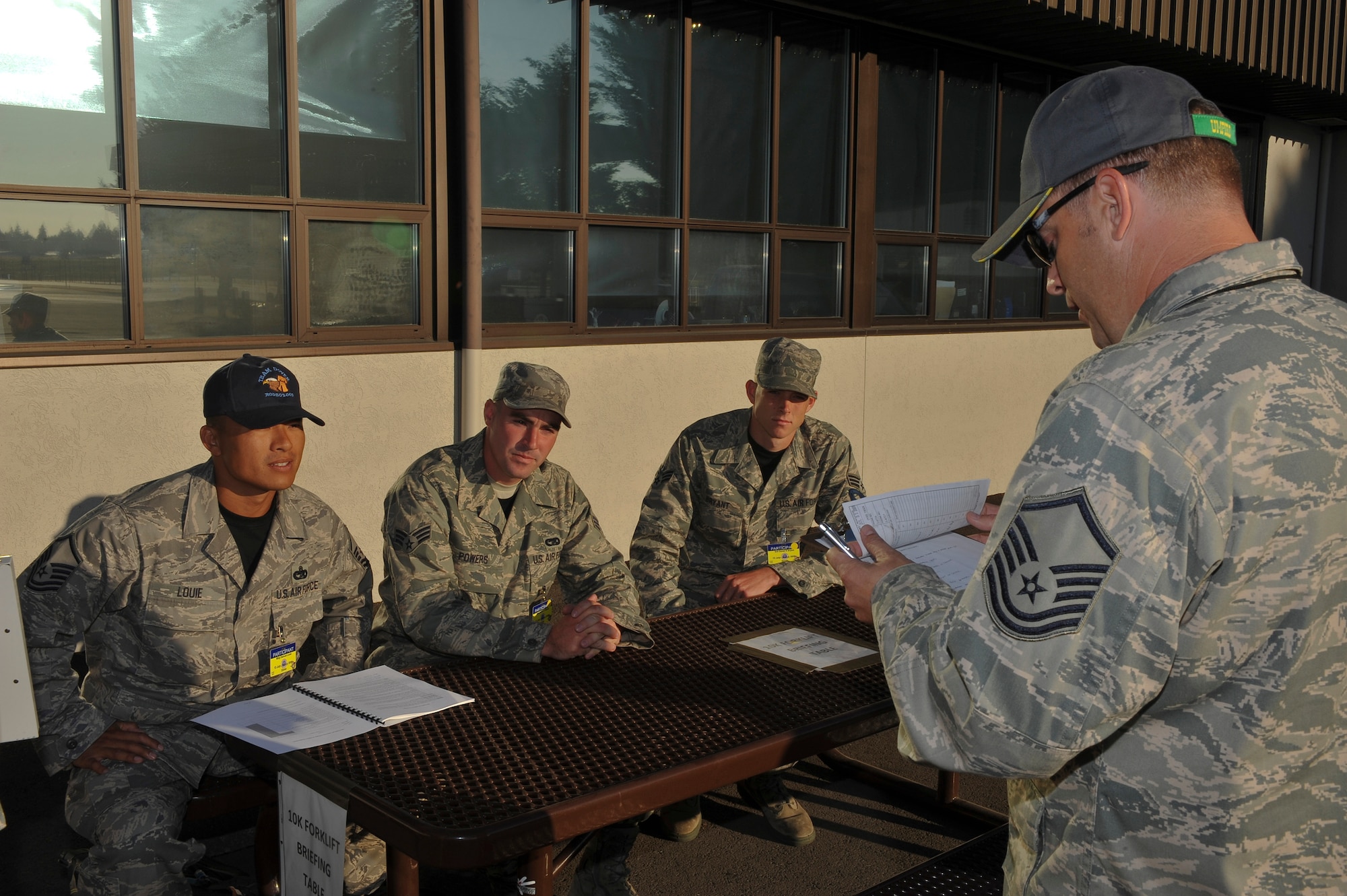 Master Sgt. Ryan Dudgeon, an umpire for the 10K forklift obstacle course, briefs the course layout and rules to Master Sgt. Samuel Louie and Senior Airmen Jonas Powers and Daniel Bryant during Air Mobility RODEO 2009, July 20.  The course is designed to test the driving and communication skills of the team.  RODEO is an international combat skills and flying operations competition designed to develop and improve techniques and procedures with our international partners to enhance mobility operations.  The competitors are from the 436th Aerial Port Squadron at Dover Air Force Base, Del.  (U.S. Air Force photo by Master Sgt. Joe Springfield/Released)