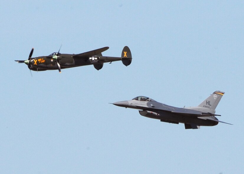 MINOT AIR FORCE BASE, N.D. -- A World War II era P-38 Lightning and a modern day F-16 Fighting Falcon fly together during a U.S. Air Force Heritage Flight demonstrating the past and present of military fighters at Northern Neighbor’s Day here, July 18. Thousands of people from the base and local community turned out to watch the 2009 Northern Neighbors Day, which came through on its promise to wow spectators with amazing aerial maneuvers, nail-biting choreography, historic displays and much more.  (U.S. Air Force photo by Staff Sgt. Keith Ballard)