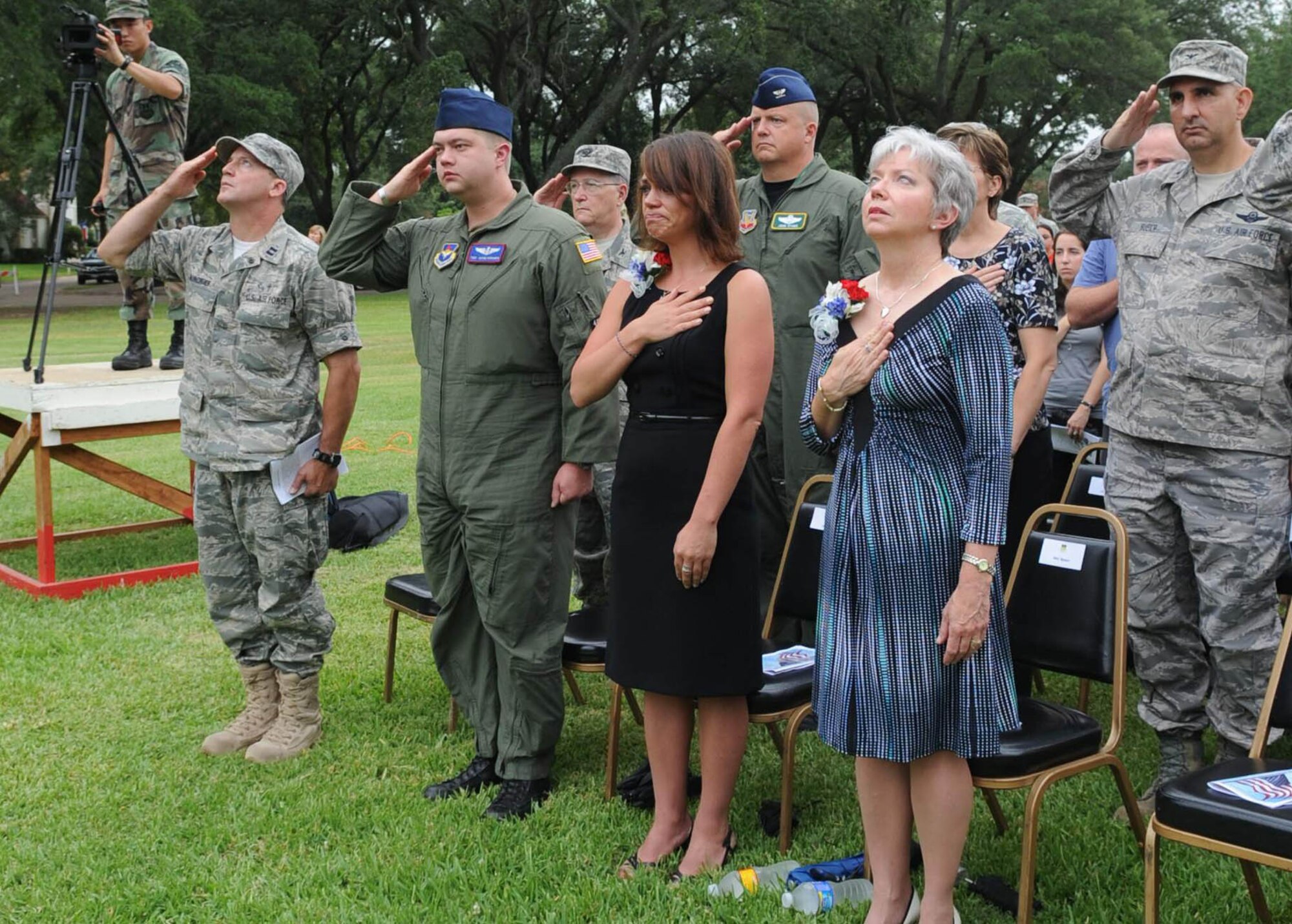 Family members, friends and Airmen at Barksdale Air Force Base, La., render courtesies as the flag is raised at the 2nd Bomb Wing flag pole July 21 during the RAIDR 21 Remembrance Ceremony.  The ceremony was held to remember the six fallen aircrew members who died in a crash July 21, 2008, while deployed to Andersen AFB, Guam. The call-sign of their B-52 Stratofortress was RAIDR 21.  (U.S. Air Force photo/Senior Airman Alexandra Longfellow) 