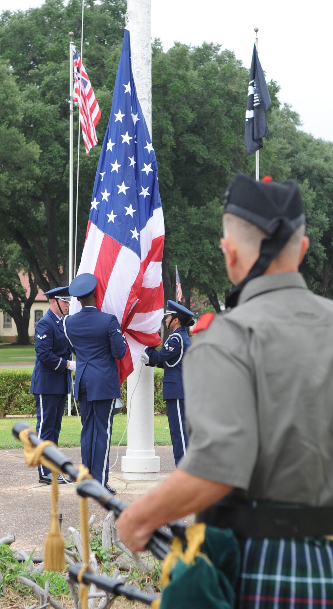 Base Honor Guard Airmen at Barksdale Air Force Base, La., raise the flag during the RAIDR 21 Remembrance Ceremony held at the 2nd Bomb Wing flag pole July 21.  More than 200 Airmen, friends and family members attended the ceremony to remember the six fallen aircrew members who died in a crash July 21, 2008, while deployed to Andersen AFB, Guam.  The call-sign of their B-52 Stratofortress was RAIDR 21.  (U.S. Air Force photo/Senior Airman Alexandra Longfellow)