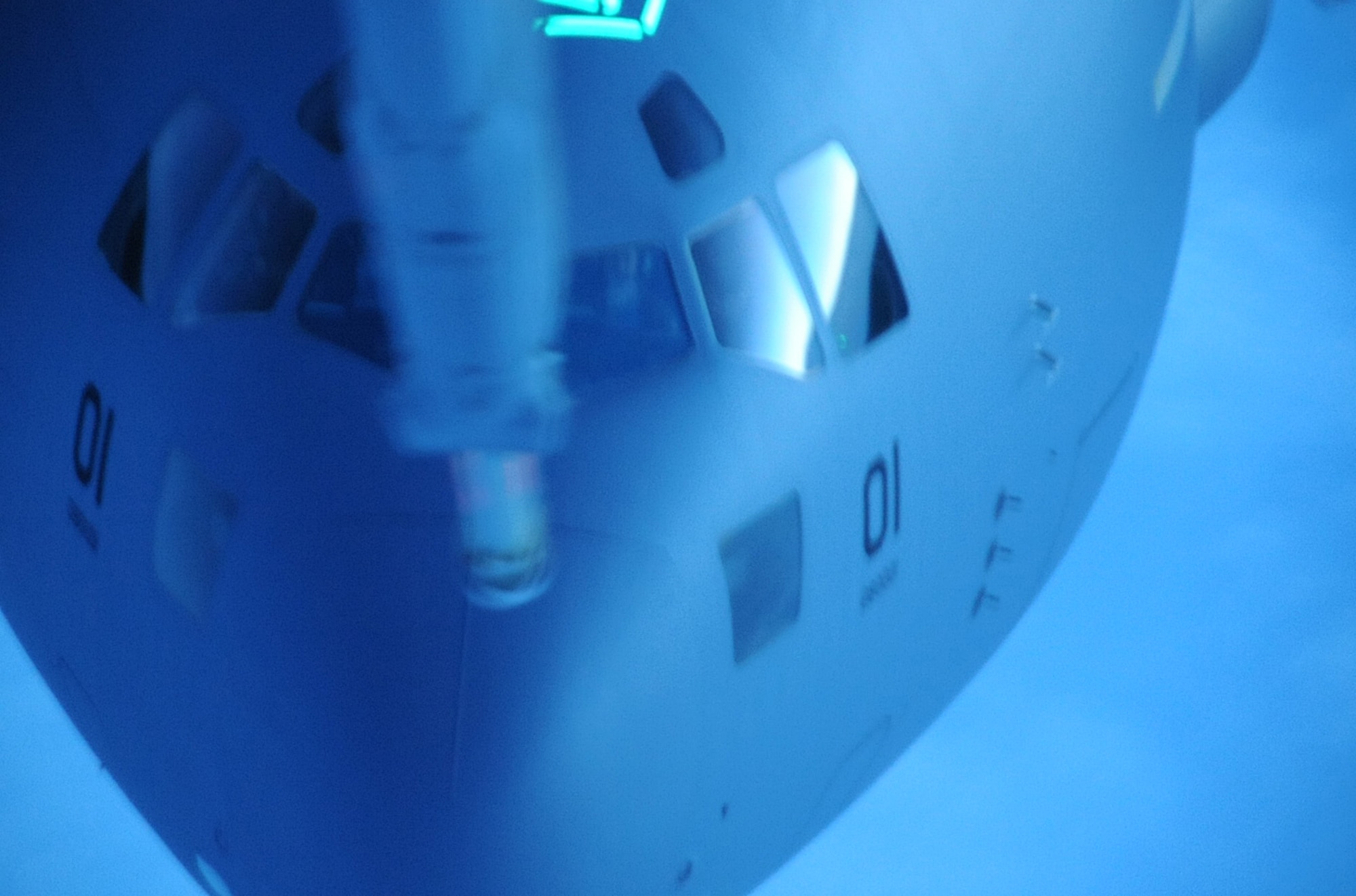 With Swedish and U.S. Air Force pilots in the cockpit, the first C-17 Globemaster III to belong to a 12-nation strategic airlift initiative approaches a Joint Base McGuire-Dix-Lakehurst tanker to receive 65,000 pounds of fuel in flight over the Atlantic Ocean July 17, courtesy of a 32nd Air Refueling Squadron crew. Despite the KC-10 crew's jokes that boom operator Master Sgt. Jody Riggs might "leave his mark" on the new C-17, the refueling went smoothly and enabled the aircraft to reach its destination - Pápa Air Base, Hungary. (U.S. Air Force photo/Staff Sgt. Danielle Johnson)