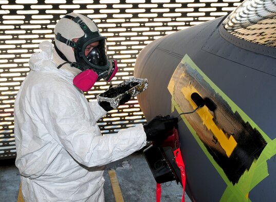 Airman 1st Class Daniel Wade, 4th Equipment Maintenance Squadron aircraft structural maintenance journeyman, paints a name plate onto an F-15E Strike Eagle at Seymour Johnson Air Force Base, N.C., July 14, 2009. Name plates show the names of the pilot and weapon systems officer on the left side of the aircraft and the crew chief and an armament Airman on the right. (U.S. Air Force photo by Airman 1st Class Rae Perry)
