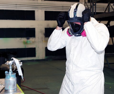 Senior Airman Jonathon Shanley, 4th Equipment Maintenance Squadron aircraft structural maintenance journeyman, dons protective gear before mixing paint for application on an F-15E Strike Eagle at Seymour Johnson Air Force Base, N.C., July 14, 2009. The Air Force requires painters to use high pressure, low volume paint guns. These paint guns place more paint on the surface leaving less in the atmosphere.   (U.S. Air Force photo by Airman 1st Class Rae Perry)