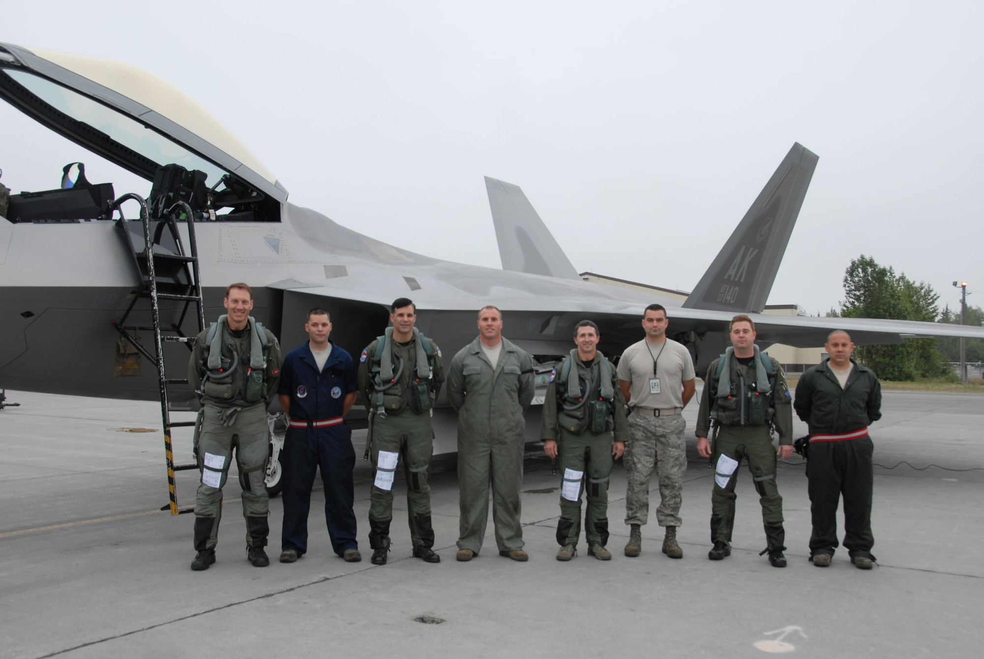 Reserve pilots and crew chiefs from the 477th Fighter Group and an active-duty pilot from the 525th Fighter Squadron pose for a commemorative photo prior to launch during the group's first-flying Unit Training Assembly on Saturday, July 11.  July's UTA marked the first opportunity since the 477th FG's activation in October 2007 that its Reservists were able to support, maintain and fly the F-22A Raptors.  (From Left to Right - Lt. Col. David 'Piff' Piffarerio, Staff Sgt. Andrew Eichorst, Lt. Col. John Hillyer, Tech. Sgt. Ernest Kunde, Lt. Col. Phil 'Axl' Rose, Tech. Sgt. Ben Waxenfelter, Capt Chesley 'Hawg' Smith (525th FS) and Staff Sgt. Derrick Ocasio.) (Air Force Photo / Maj. Cary McPartlin)