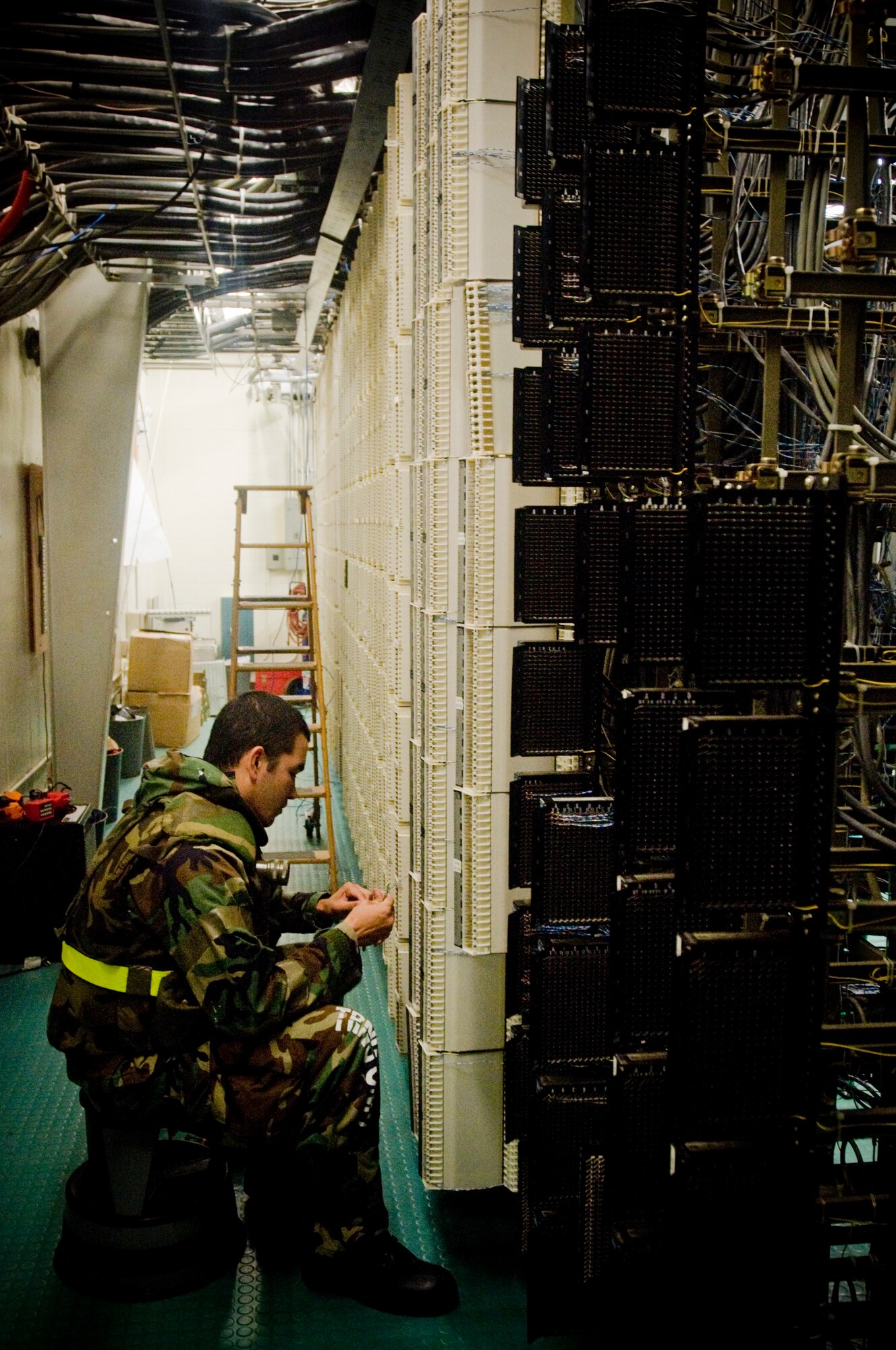 KUNSAN AIR BASE, Republic of Korea -- Airman 1st Class Christopher Reynolds moves telephone cable July 21. Airman Reynolds is from the 8th Communications Squadron and ensures that telecommunications stay open during the operationa readiness exercise. (U.S. Air Force photo by Senior Airman Jonathan Steffen)