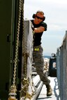 Senior Airman Daniel Bryant, 436th Aerial Port Squadron, pushes a pallet off of a 60K loader during a graded exercise July 20. Aerial Porters from the 512th and 436th Airlift Wings team up at the Air Mobility RODEO at McChord Air Force Base, Wash., where they are graded on various exercises aimed at moving cargo and passengers. (U.S. Air Force photo/Staff Sgt. Steve Lewis)