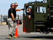 Senior Airman Coban Goertz, 46th Aerial Port Squadron 60K loader driver, gets help from spotters from the 436th Aerial Port Squadron as he backs up while trying to avoid hitting cones July 20. Team Dover aerial porters are participating in the Air Mobility RODEO at McChord Air Force Base, Wash., where they are graded on various exercises aimed at moving cargo and passengers. More than 100 teams are participating in RODEO, including teams from seven foreign countries. The international combat skills and flying operations competition is designed to develop and improve techniques, procedures and enhance mobility operations. (U.S. Air Force photo/Staff Sgt. Steve Lewis)