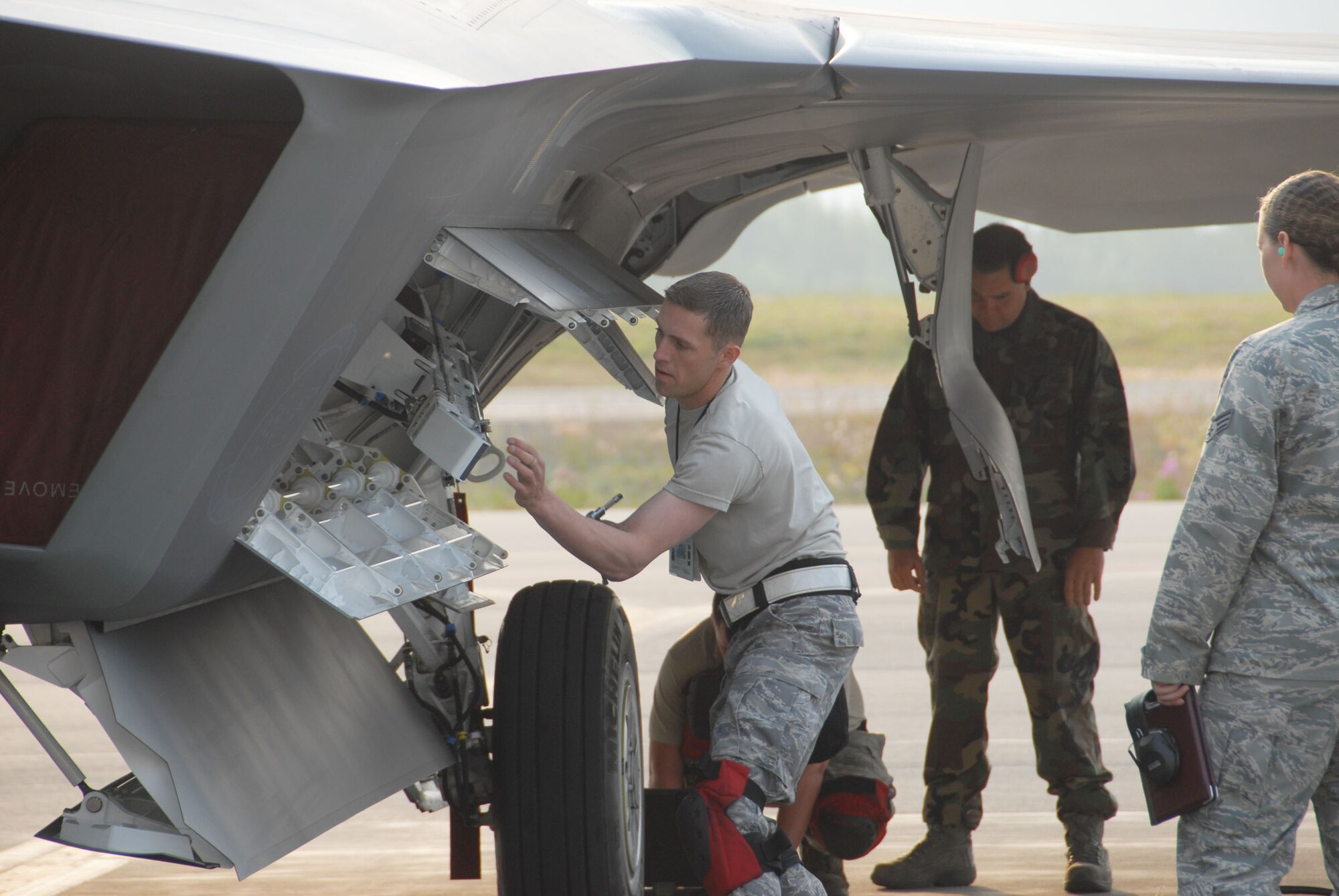 Staff Sgt. Nick Barnes, 477th Fighter Group Aircraft Maintenance Squadron weapons loader, preps the missile bay during the 3rd Wing's Load Crew Competition held on July 10.  This was first time a Reserve team from the 477th AMXS took part in the quarterly event.  During the competition four teams competed in several different challenges including a toolbox inspection, uniform inspection, knowledge test and weapons load challenge.  During the weapons load challenge, the 477th AMXS team loaded weapons on an F-22A Raptor with incredible speed - completing the load in a time of 33:26. (Air Force Photo / Maj. Cary McPartlin)