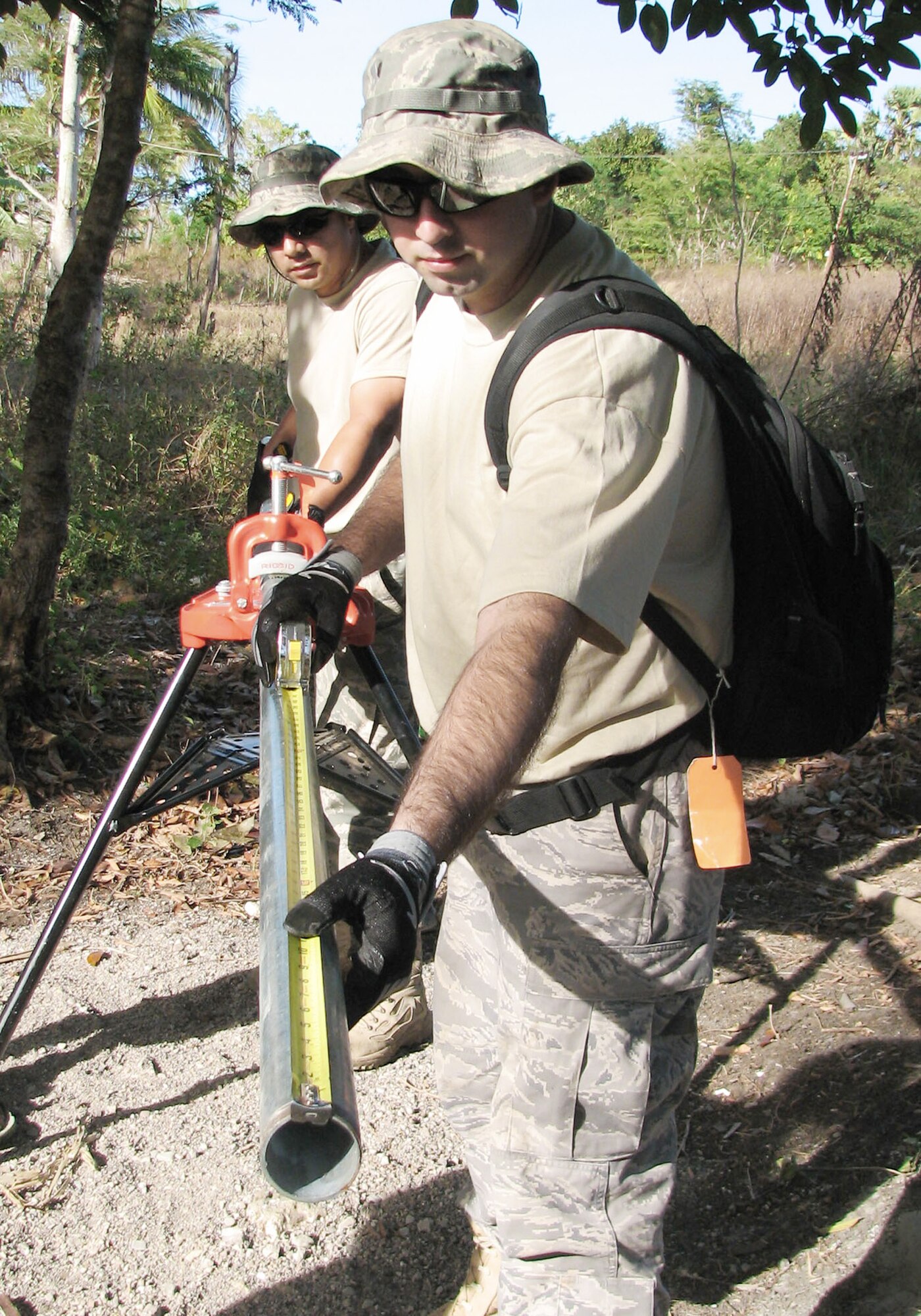 Senior Airman Henry Benitez measures a water distribution pipe July 17 that will connect between a well and water pump in Naioni, Indonsesia. Once installed, the pump will transfer water more than 900 feet to a water storage tank. Airman Benitez, a utilities specialist assigned to the 15th Civil Engineer Squadron at Hickam Air Force Base, Hawaii, and other Airmen worked with Indonesian military members and civilians on the project as part of Operation Pacific Angel 2009. Pacific Angel is a Pacific Air Forces humanitarian and civic assistance operation led by 13th Air Force at Hickam Air Force Base, Hawaii. (U.S. Air Force photo/Senior Master Sgt. Russell Dodson) 
