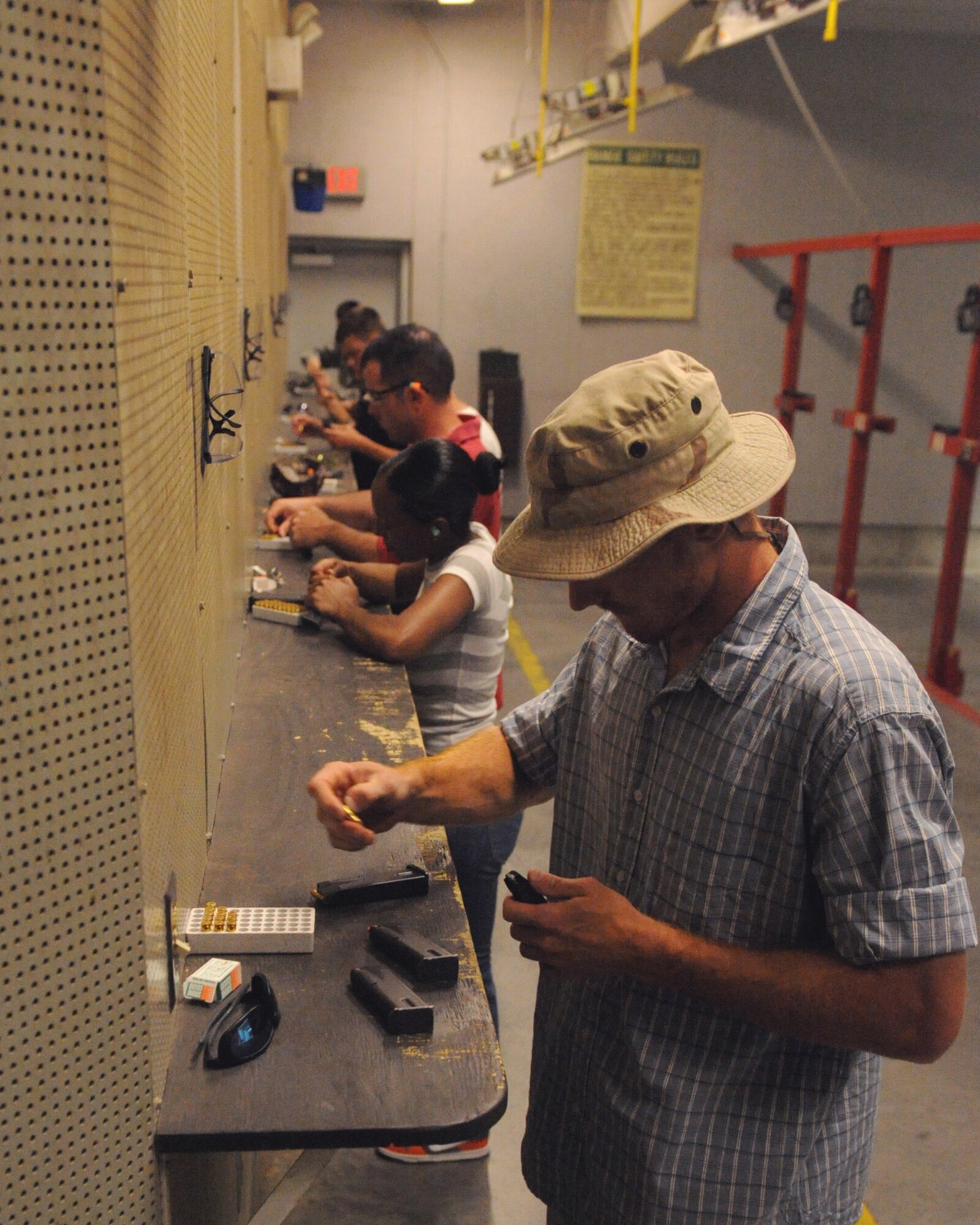 Contestants load 9mm pistol magazines before the Combat Arms Excellence in Competition 9mm Pistol Competition on Seymour Johnson Air Force Base, N.C., July 18, 2009. The program is open to any Air Force active duty, reserve, national guard members, Department of Defense civilians and dependants over the age of 18.  Individuals can earn awards by earning points in marksmanship competitions hosted by military services. (U.S. Air Force photo by Airman 1st Class Whitney S. Lambert) 