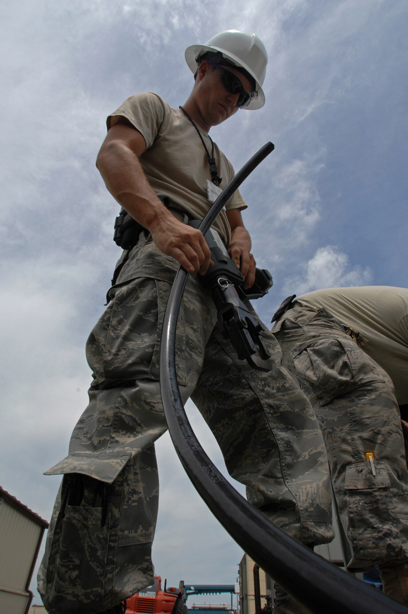 WHITEMAN AIR FORCE BASE, Mo. - Senior Airman Aaron Burgan, 509th Civil Engineer Squadron, prepares to cut a copper wiring while replacing a transformer after an un-replaceable fuse had blown, July 21. Both Airmen Burgan and Senior Airman Daniel Colantino were called late at night while on standby status and worked around the clock to ensure the transformer was properly replaced. (U.S. Air Force photo/Senior Airman Kenny Holston)