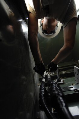 WHITEMAN AIR FORCE BASE, Mo. - Senior Airman Aaron Burgan, 509th Civil Engineer Squadron, works to replace a transformer after an un-replaceable fuse had blown, July 21. Both Airmen Burgan and Senior Airman Daniel Colantino were called late at night while on standby status and worked around the clock to ensure the transformer was properly replaced. (U.S. Air Force photo/Senior Airman Kenny Holston)