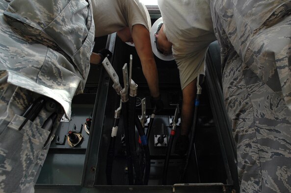 WHITEMAN AIR FORCE BASE, Mo. - Senior Airman Aaron Burgan, and Daniel Colantino, 509th Civil Engineer Squadron, work together to replace a transformer after an un-replaceable fuse had blown, July 21. Both Airmen Burgan and Colantino were called late at night while on standby status and worked around the clock to ensure the transformer was properly replaced. (U.S. Air Force photo/Senior Airman Kenny Holston)