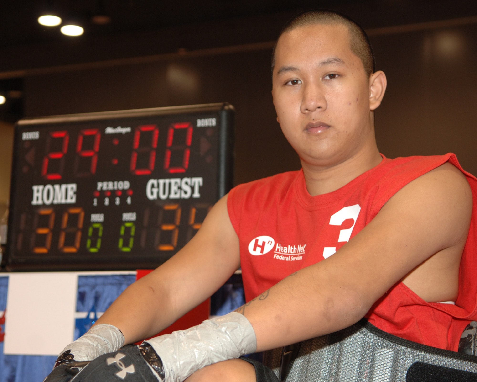 SPOKANE, Wash. -- Tim Vixay, an Oregon City, Ore., native, poses in front of the score board after winning his first quad rugby game at the National Veterans Wheelchair Games held here July 15.  Vixay is a 21-year-old Marine Corps veteran, which makes him the youngest player at the NVWG. Vixay plays for the Portland Pounders, a rugby team in his home state of Oregon. (U.S. Air Force photo / Senior Airman Jocelyn A. Guthrie)

