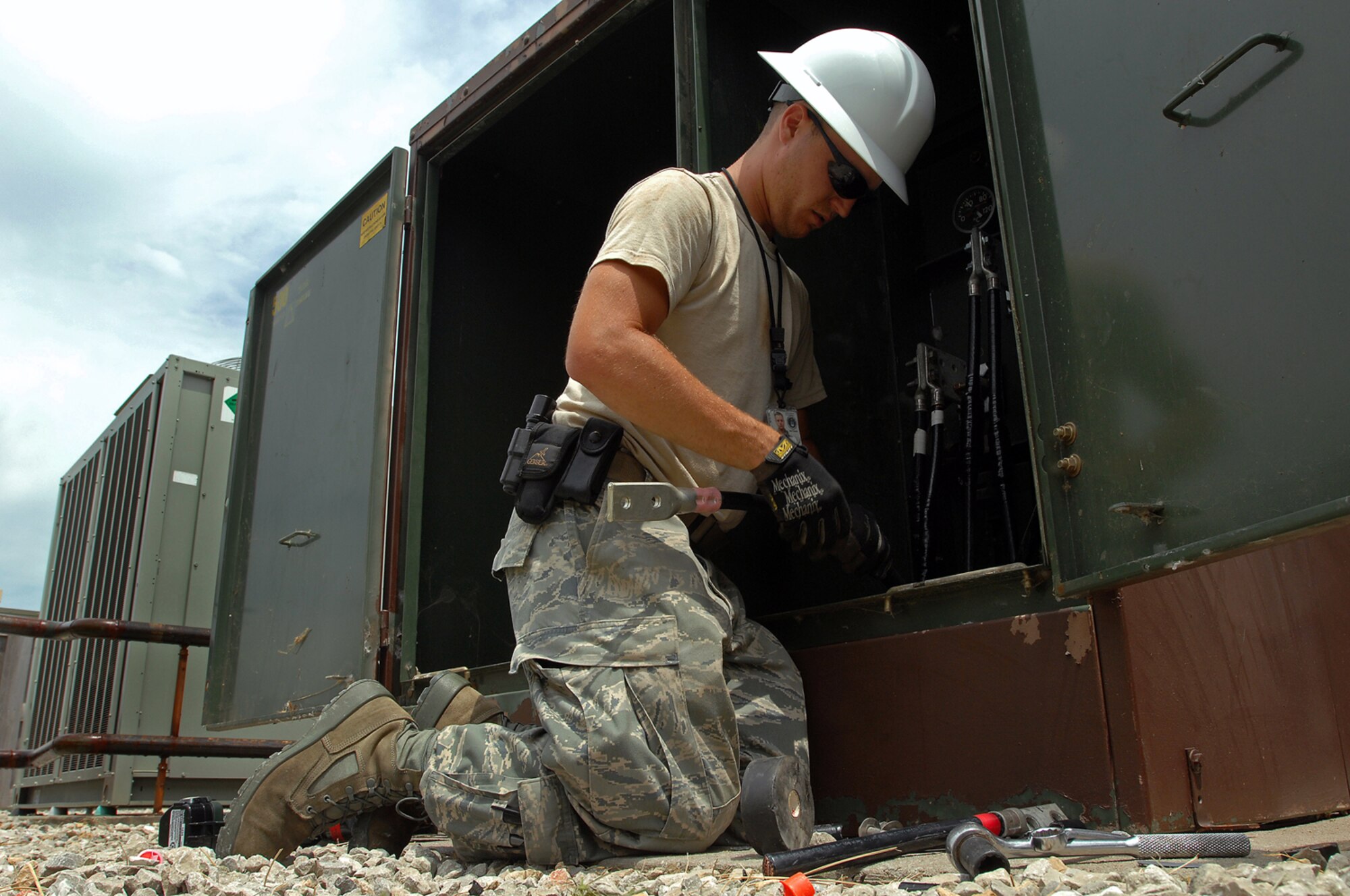 WHITEMAN AIR FORCE BASE, Mo. - Senior Airman Aaron Burgan, 509th Civil Engineer Squadron, works to replace a transformer after an un-replaceable fuse had blown, July 21. Both Airmen Burgan and Colantino were called late at night while on standby status and worked around the clock to ensure the transformer was properly replaced. (U.S. Air Force photo/Senior Airman Kenny Holston)