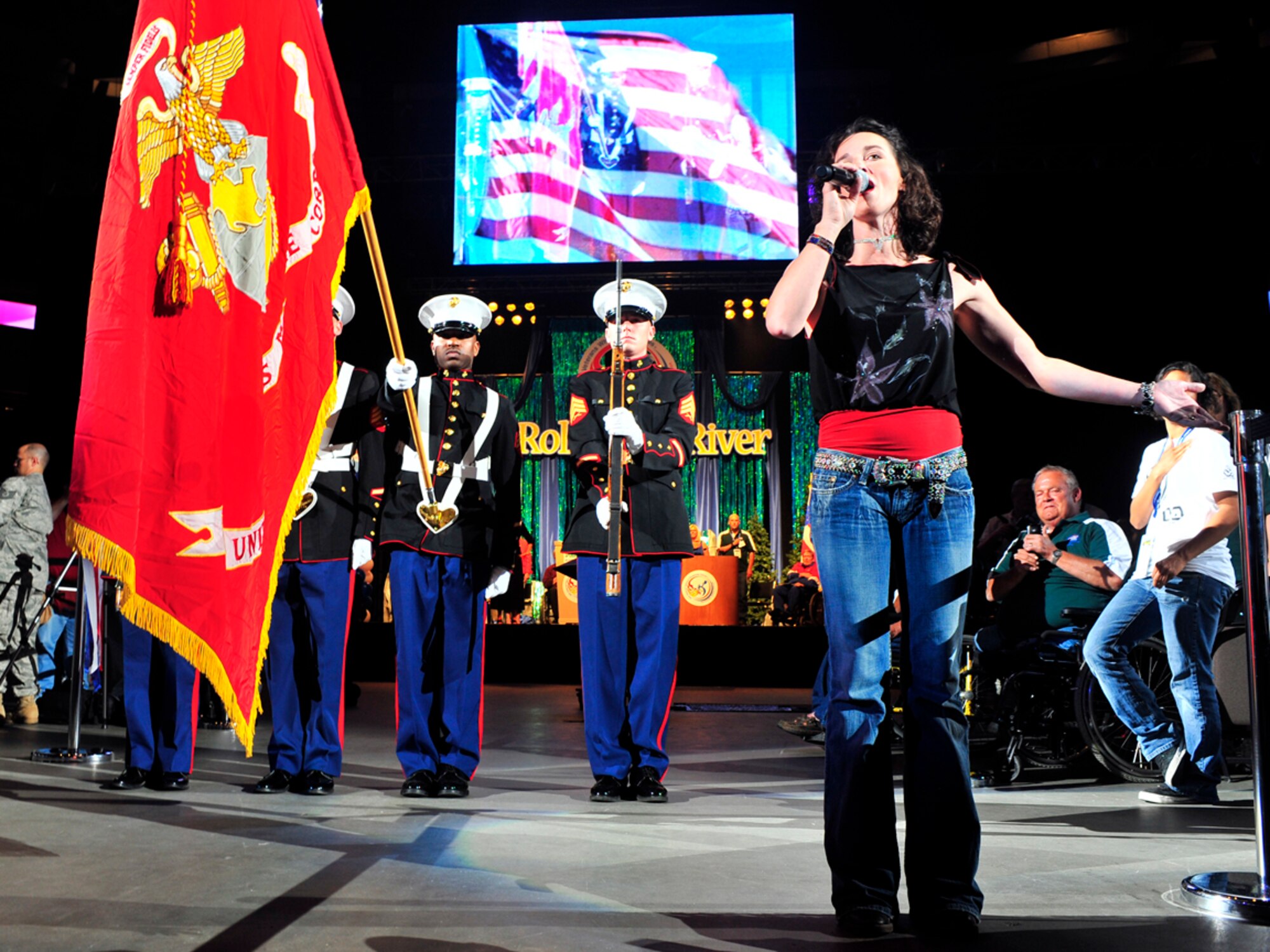 SPOKANE Wash. – Amy Clawson, nationally recognized country and western performer, sings the national anthem while a U.S. Marine Corps color guard presents the colors during the 29th Annual Veterans Wheelchair Games at the Spokane Arena July 13. (U.S. Air Force photo / Senior Airman Joshua K. Chapman)
