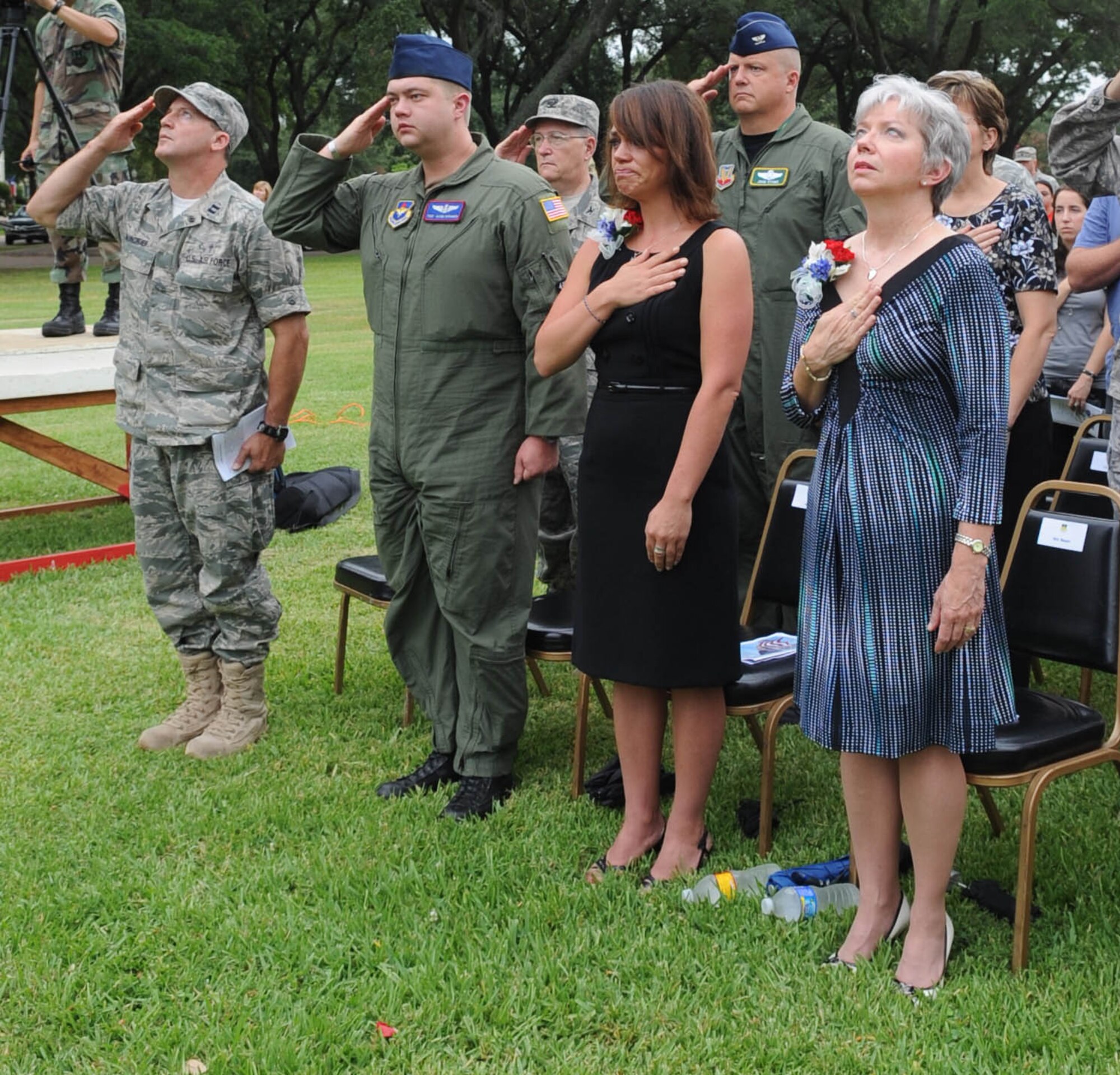 BARKSDALE AIR FORCE BASE, La. -- Members of Barksdale, friends and family members of the RAIDR 21 aircrew render courtesies as the flag is raised during a remembrance ceremony held at the 2d Bomb Wing flag pole July 21. The RAIDR 21 crew crashed off the coast of Guam a year ago today.  (United States Air Force photo by Senior Airman Alexandra Longfellow) (RELEASED)