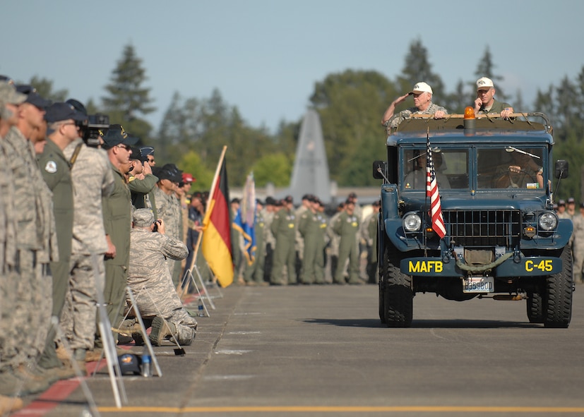 Gen. Arthur J. Lichte salutes the crowd while riding next Maj. Gen Brooks Bash prior to the opening ceremony at McChord Air Force Base, Wash., July 19. RODEO is an international combat skills and flying operations competition designed to develop and improve techniques and procedures with our international partners to enhance mobility operations. General Lichte is the Air Mobility Command commander at Scott AFB, Ill., and General Bash is the RODEO 2009 commander. (U.S. Air Force photo/Staff Sgt. Stephen Schester)  