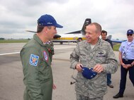 DAYTON, Ohio (AFMCNS) – Gen Donald Hoffman, commander of Air Force Materiel Command, converses with Lt Col José Aguinaldo de Moura , commander of Brazil’s Esquadrilha da Fumaça, or “Smoke Squadron.” The Brazilian Smoke Squadron performed July 18 and 19 at the 2009 Vectren Dayton Air Show at the Dayton International Airport. General Hoffman met with Colonel Moura’s team, which is known for its fast-paced, close-up aerobatics and smoke displays, after its Saturday performance. Also on hand was Maj Gen Stefan Egon Gracza, Brazilian Defense and Air Attaché (background, right). The team flies the Embraer T-27 Tucano aircraft. (Air Force photo by Kathleen A.K. López)
