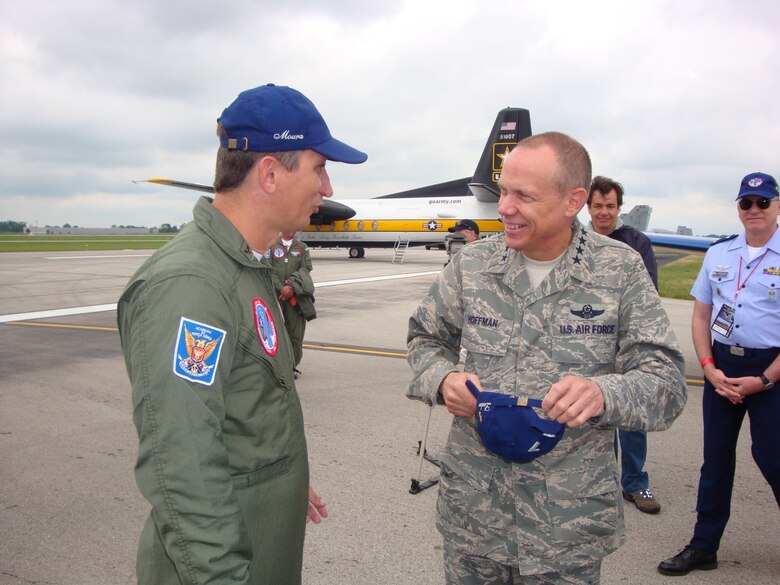 DAYTON, Ohio (AFMCNS) – Gen Donald Hoffman, commander of Air Force Materiel Command, converses with Lt Col José Aguinaldo de Moura , commander of Brazil’s Esquadrilha da Fumaça, or “Smoke Squadron.” The Brazilian Smoke Squadron performed July 18 and 19 at the 2009 Vectren Dayton Air Show at the Dayton International Airport. General Hoffman met with Colonel Moura’s team, which is known for its fast-paced, close-up aerobatics and smoke displays, after its Saturday performance. Also on hand was Maj Gen Stefan Egon Gracza, Brazilian Defense and Air Attaché (background, right). The team flies the Embraer T-27 Tucano aircraft. (Air Force photo by Kathleen A.K. López)