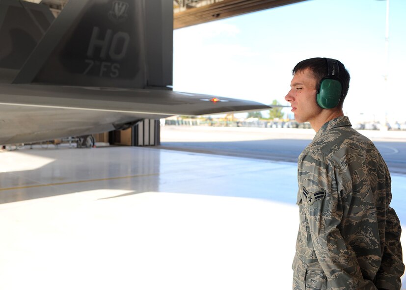 Airman 1st Class Samuel Beety, 49th Aircraft Maintenance Unit, watches as the final checks are being performed on an F-22A Raptor before its departure to Red Flag at Holloman Air Force Base, N.M., July 18. Airman Beety was a part of a two-man team who prepared the F-22 for takeoff. (U.S. Air Force photo/ Airman 1st Class DeAndre Curtiss)