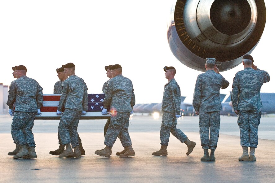 An Army carry team transfers the remains of Army Spc. Carlos E. Wilcox, of Cottage Grove, Minn., at Dover Air Force Base, Del., July 18. Spc. Wilcox was assigned to the 34th Military Police Company, 34th Infantry Division, Minnesota Army National Guard, Stillwater, Minn. (U.S. Air Force photo/Roland Balik)