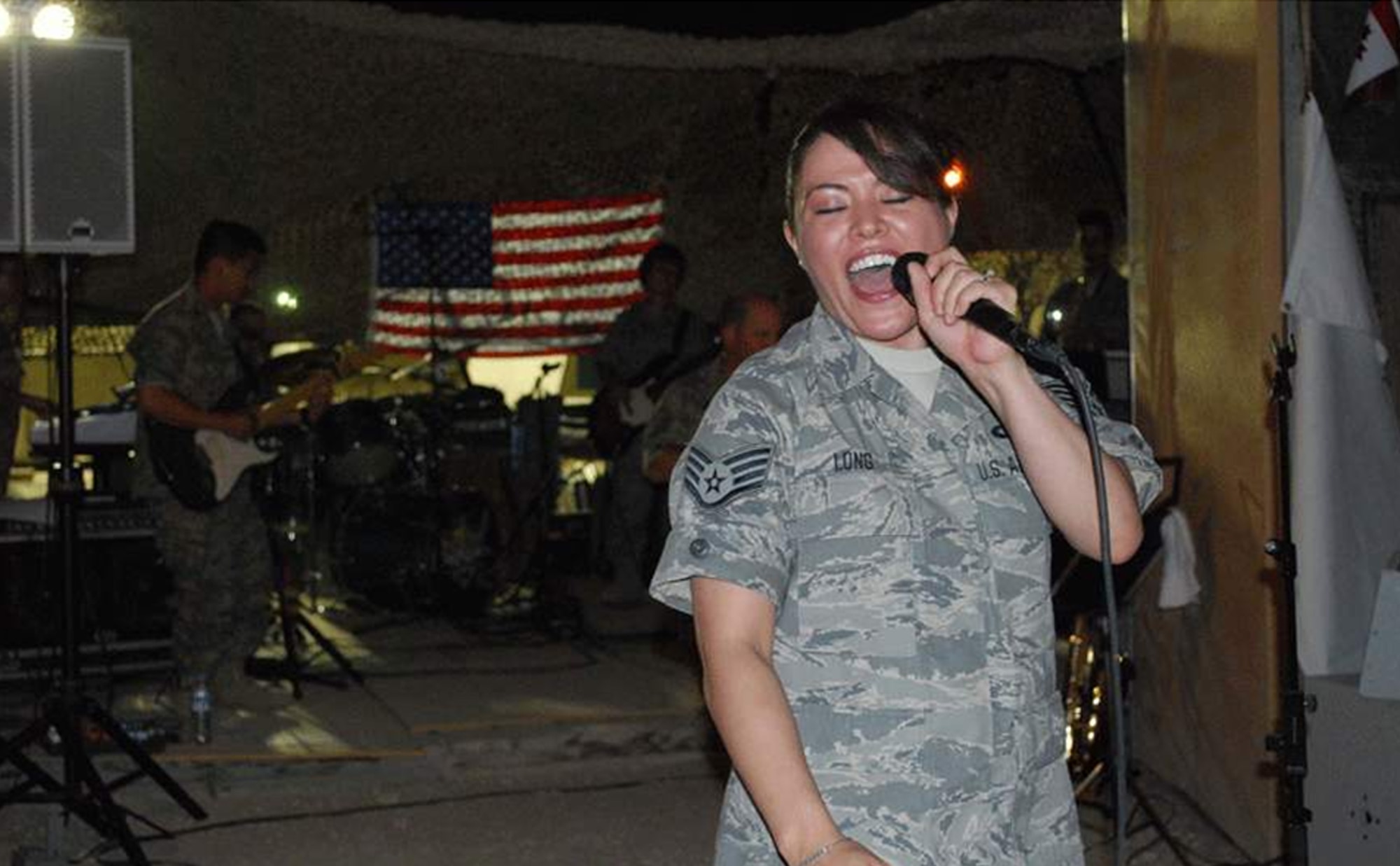 ? U.S. Air Force Staff Sgt. Angie Long  performs for U.S. and Coalition forces at a deployed location in Southwest Asia on July 7.  As the lead female vocalist of the AFCENT Band Mirage, she has performed for military personnel supporting both Operations Iraqi Freedom and Enduring Freedom.   Sergeant Long, who is deployed from the Air National Guard Band of the Central States in Missouri, hails from St. Louis. (Photo by Lt. Col. Reid Christopherson)
